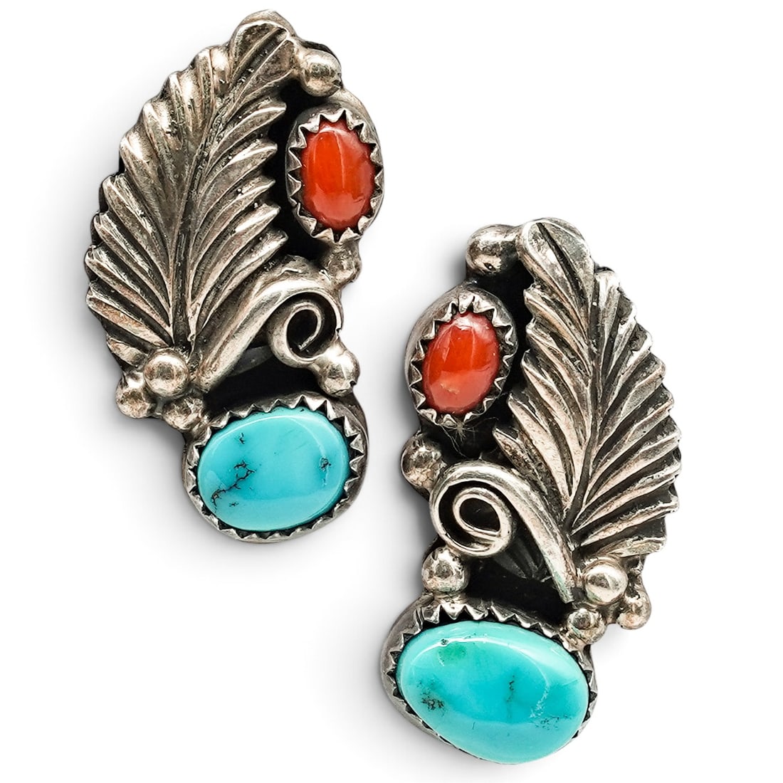 A Pair Of Navajo Sterling Silver, Turquoise, And Coral Feather Post Earrings: A pair of Navajo sterling silver, turquoise, and coral feather post earrings Late 20th century Stamped: Sterling. Each with bezel-set turquoise and coral cabochons accented by a feather motif, scrollw