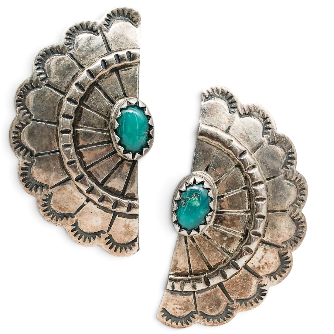 A Pair Of Navajo Sterling Silver And Turquoise Fan Post Earrings: A pair of Navajo sterling silver and turquoise fan post earrings Late 20th century Stamped: Sterling Each fan-form post earring is set with a small oval turquoise cabochon in a serrated bezel, with ra
