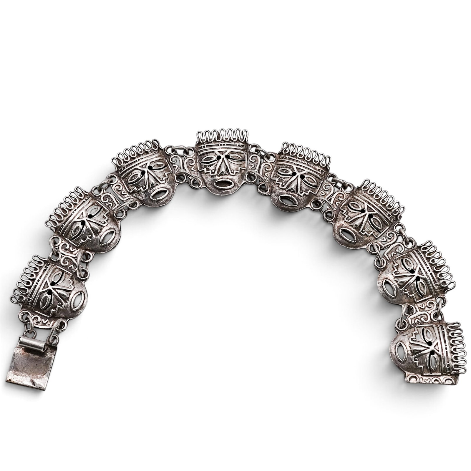 A Mexican Sterling Silver Aztec Head Link Bracelet: A Mexican sterling silver Aztec head link bracelet Late 20th century Stamped: Hecho En Mexico / 925 / MLR. An articulated bracelet composed of stylized aztec head links with openwork facial features a