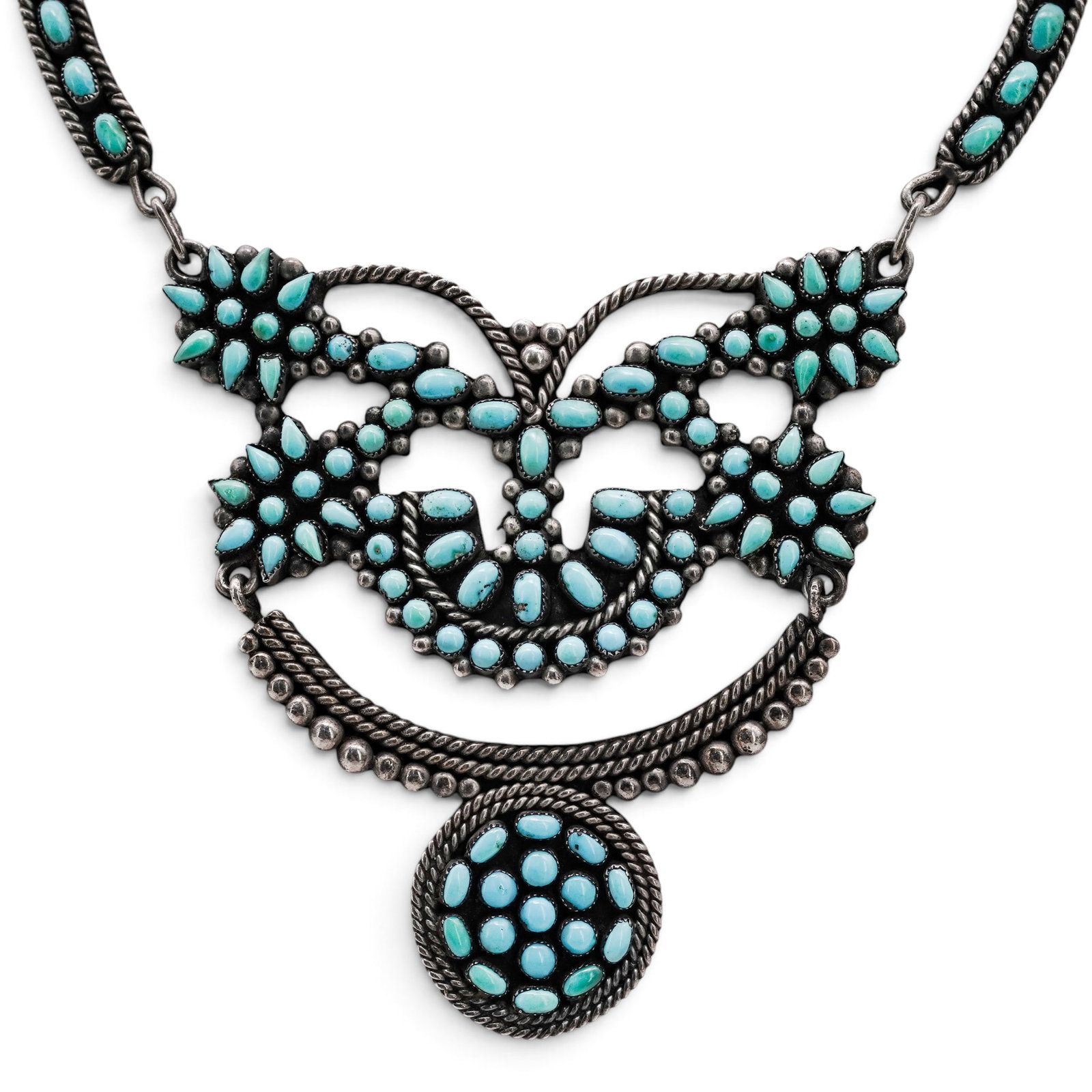 A Navajo Sterling Silver And Turquoise Cluster Panel Necklace: A Navajo sterling silver and turquoise cluster panel necklace Late 20th century Unmarked. Tested sterling silver. A necklace centered by a butterfly-form cluster panel composed of numerous turquoise c