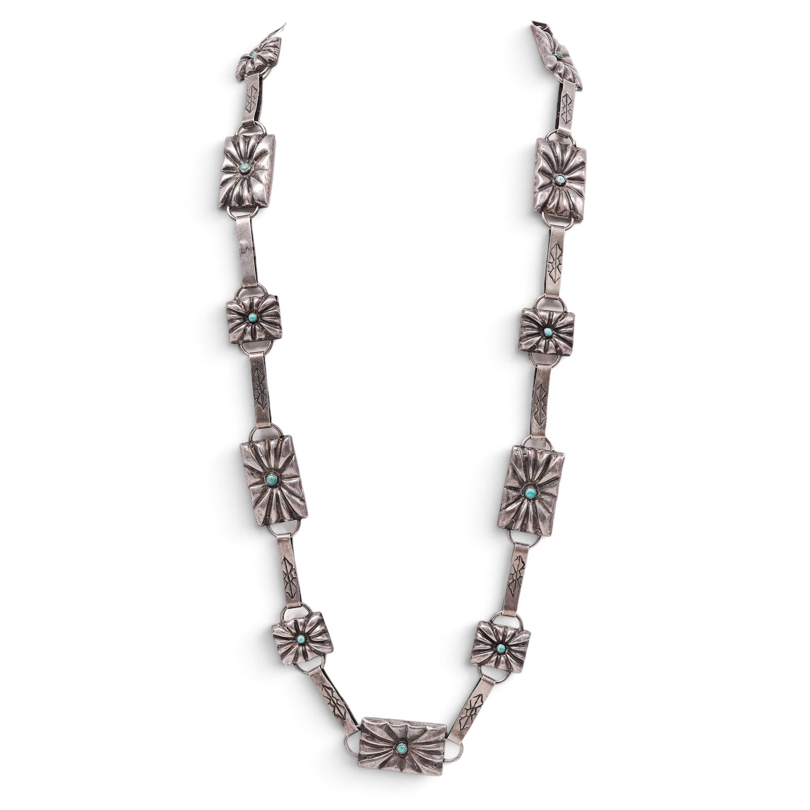 A Navajo Sterling Silver And Turquoise Concho Link Necklace: A Navajo sterling silver and turquoise concho link necklace Late 20th century Unmarked. Tested sterling silver. A necklace composed of alternating rectangular and square concho links, each centered by