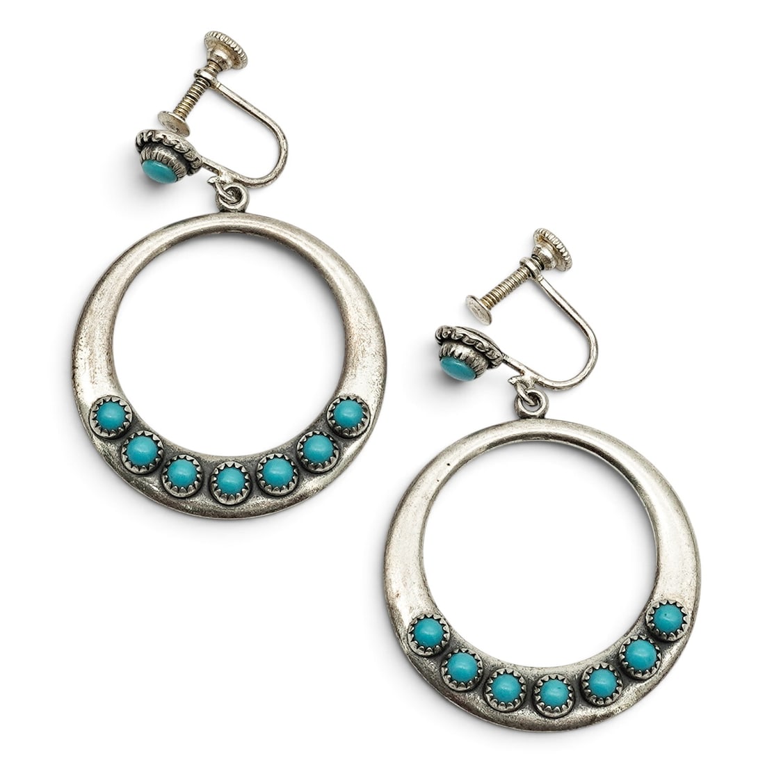 A Pair Of Navajo Sterling Silver And Turquoise Hoop Screwback Earrings: A pair of Navajo sterling silver and turquoise hoop screwback earrings Late 20th Century Stamped: Sterling. Each circular hoop accented with a row of bezel-set turquoise cabochons suspended from screw