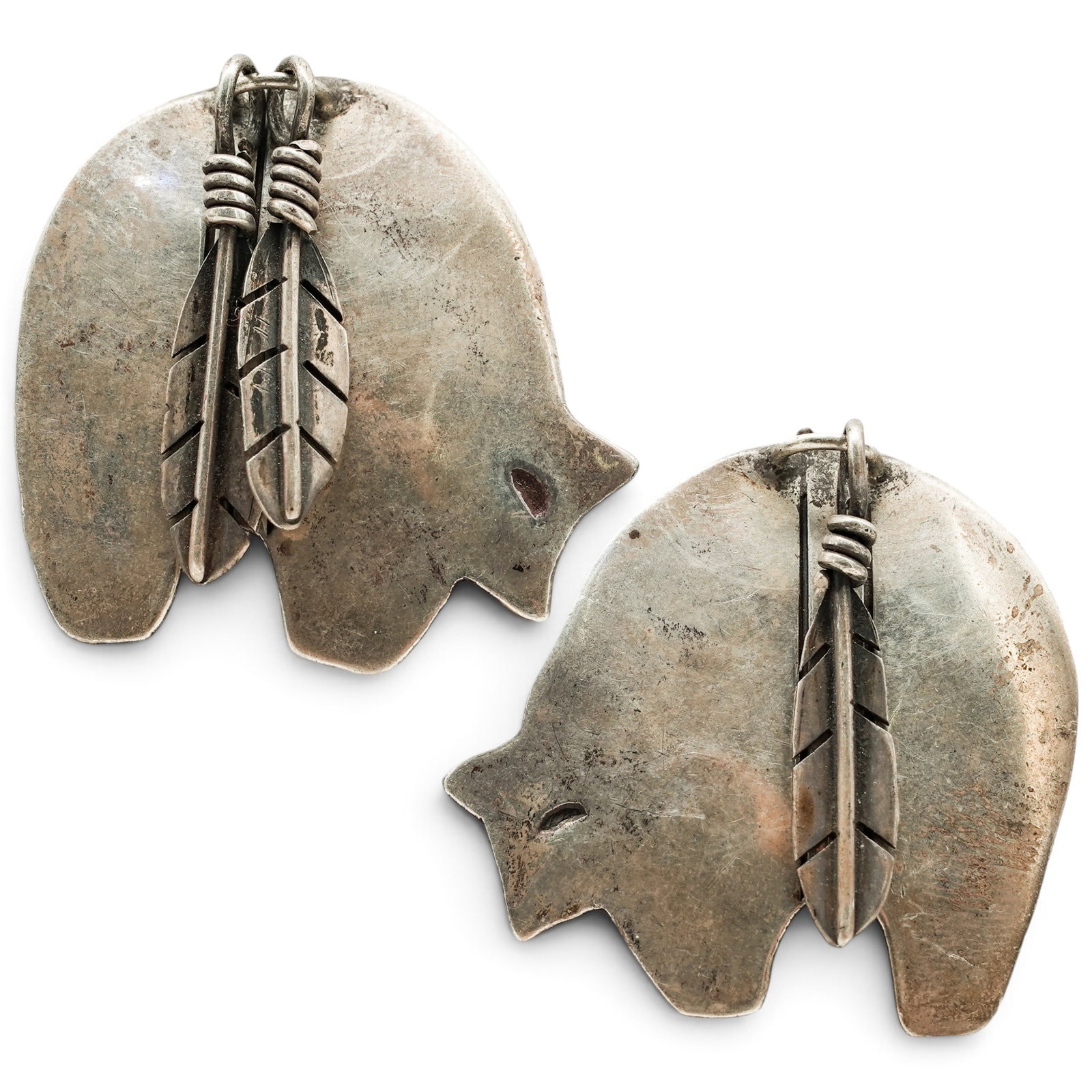 A Pair Of Navajo Sterling Silver Bear And Feather Clip Earrings: A pair of Navajo sterling silver bear and feather clip earrings Late 20th Century Stamped: M.A., unidentified makers mark / Sterling. Each in the form of a stylized bear with applied feather and wirew