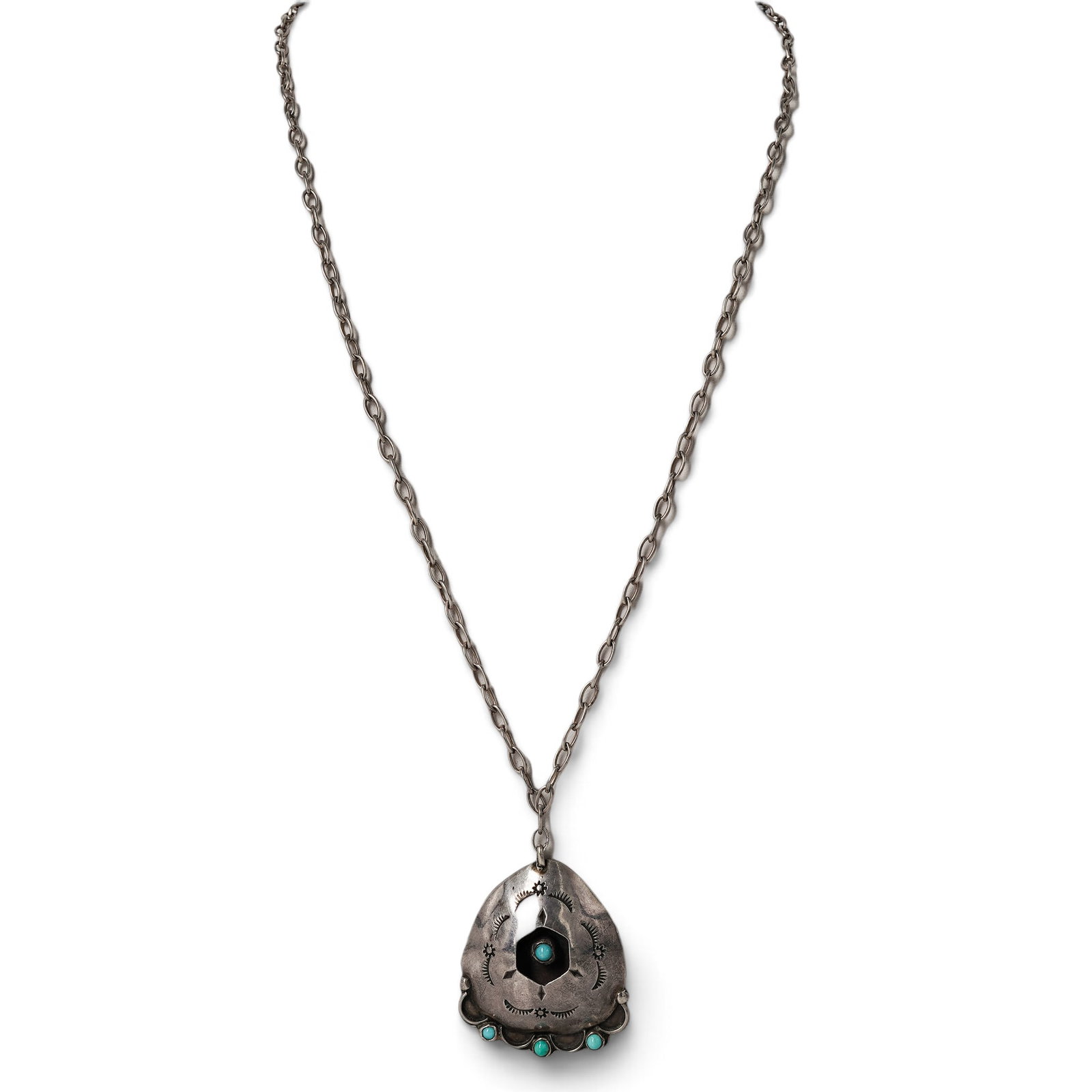 A Navajo Sterling Silver, Turquoise, And Black Stone Concho Pendant Necklace: A Navajo sterling silver, turquoise, and black stone concho pendant necklace Late 20th century Unmarked. Tested sterling silver. A necklace suspending a shield-form concho pendant with a central black