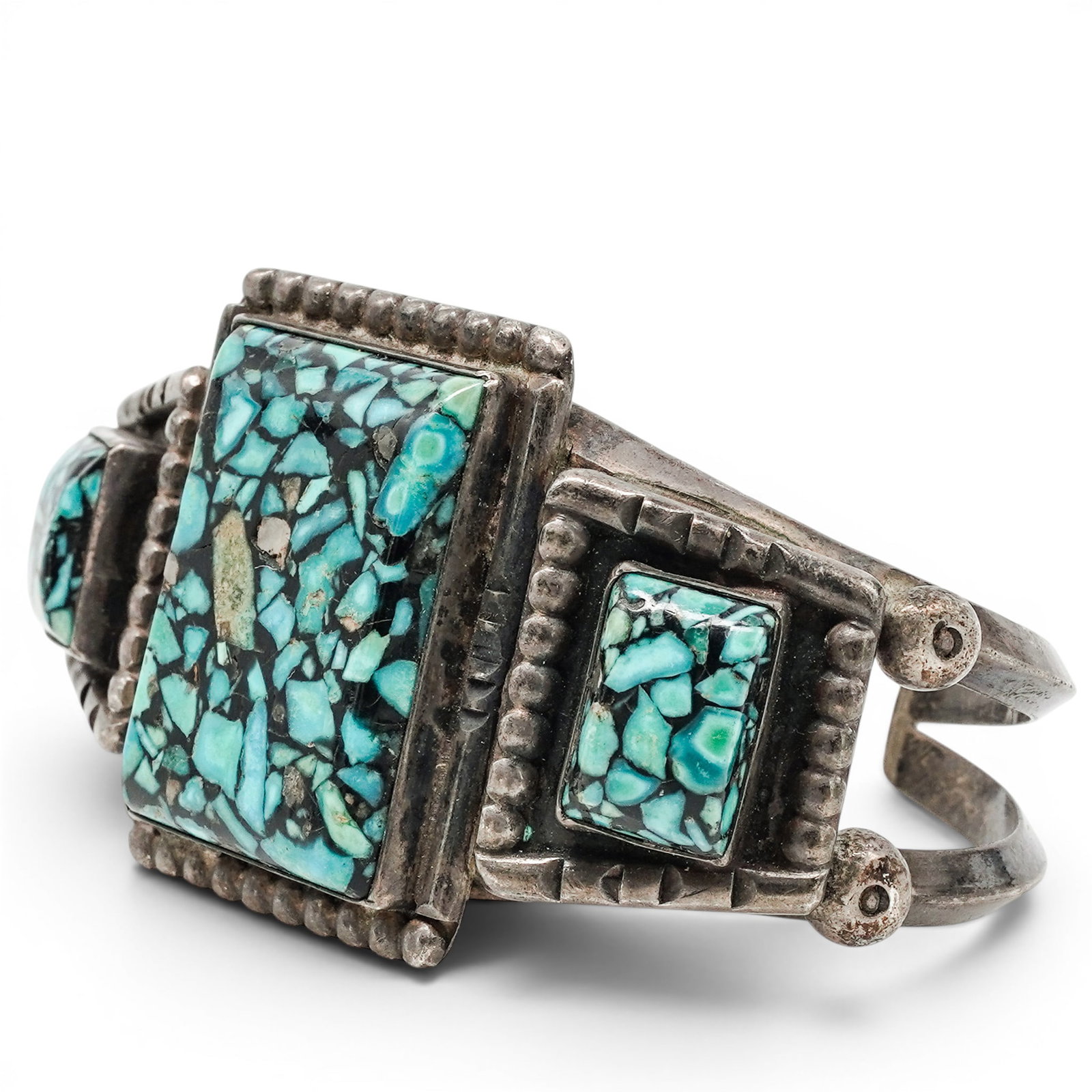 A Navajo Sterling Silver And Turquoise Mosaic Inlay Cuff Bracelet: A Navajo sterling silver and turquoise mosaic inlay cuff bracelet Late 20th century Unmarked. Tested sterling silver. A wide cuff bracelet with three rectangular turquoise mosaic inlay panels, separat