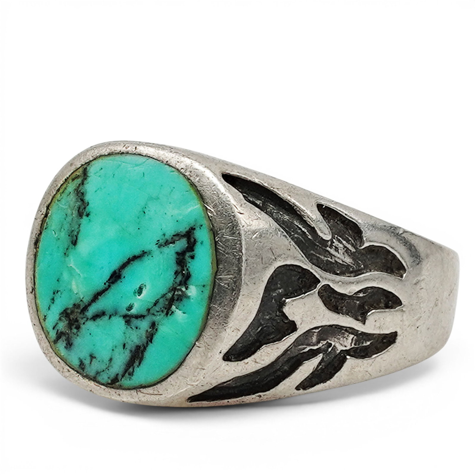 A Navajo Sterling Silver And Turquoise Signet Ring: A Navajo sterling silver and turquoise signet ring Late 20th century Stamped: .925 / illegible hallmark. A substantial signet-style ring set with an oval turquoise cabochon in a flush bezel mount, wit