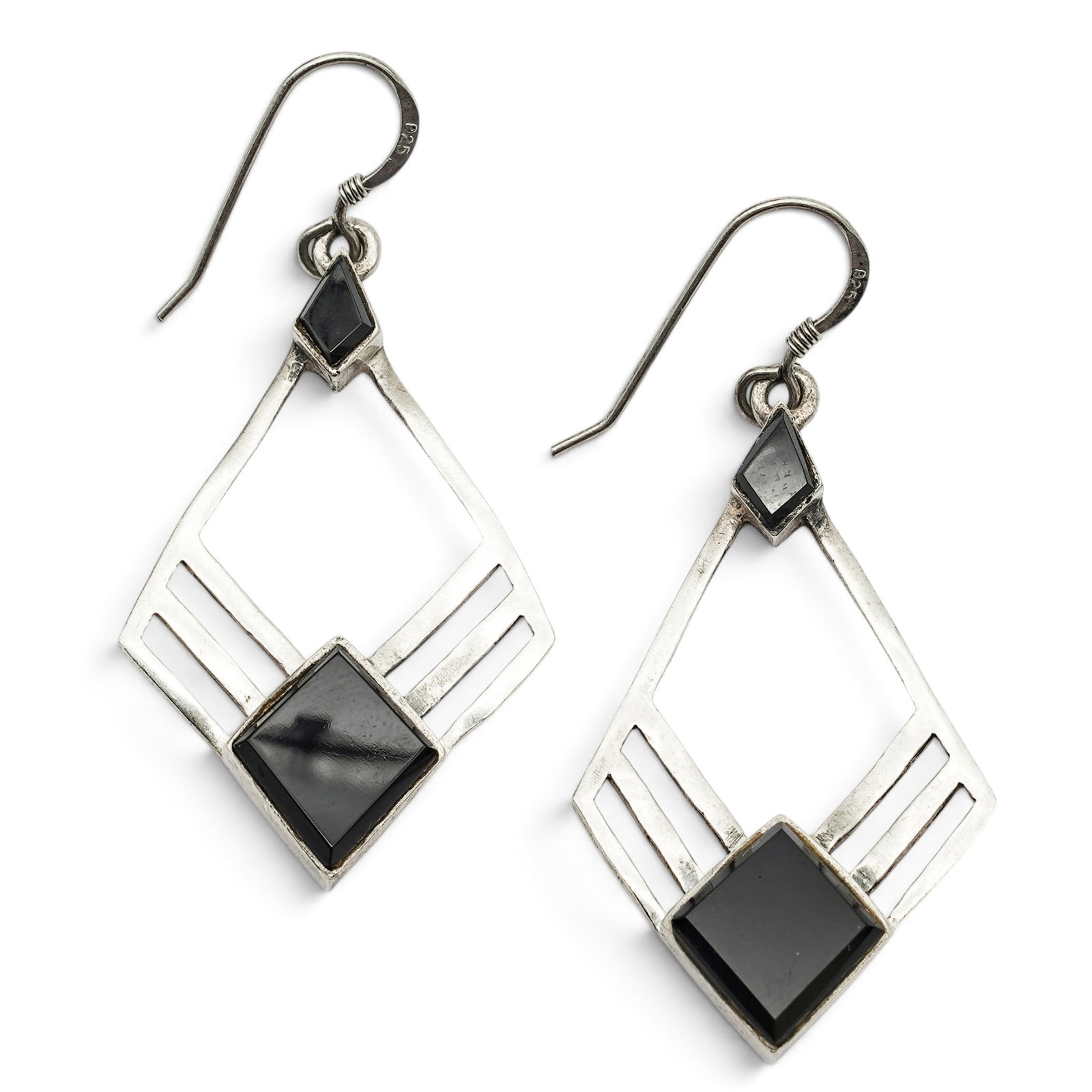 A Pair Of Sterling Silver And Onyx Geometric Earrings: A pair of sterling silver and onyx geometric earrings Late 20th century Unmarked Tests for sterling. Each openwork geometric drop earring is set with square and lozenge-form onyx cabochons in smooth b