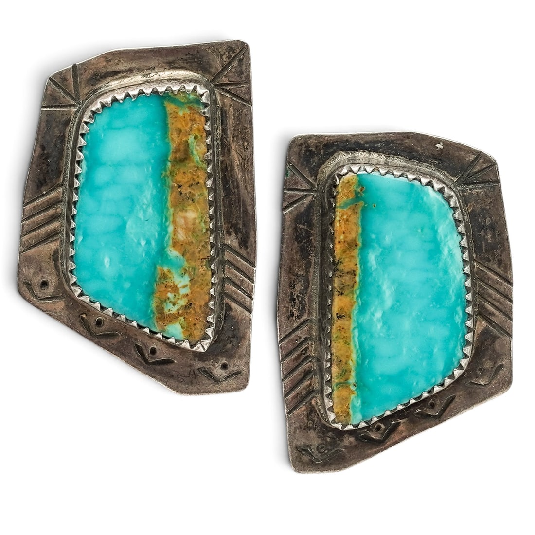 A Pair Of Navajo Sterling Silver And Turquoise Stamped Post Earrings: A pair of Navajo sterling silver and turquoise stamped post earrings Late 20th century Stamped: C.L., unidentified maker / Sterling Each with a trapezoidal turquoise cabochon in a serrated bezel setti