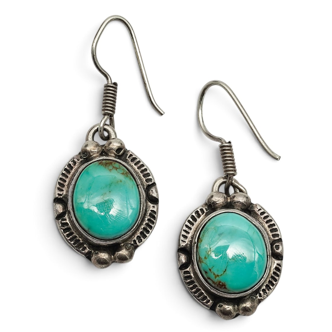 A Pair Of Navajo Sterling Silver And Turquoise Dangle Earrings: A pair of Navajo sterling silver and turquoise dangle earrings Late 20th century Stamped: Sterling / Dolphin hallmark / 925. Each with a round bezel-set turquoise cabochon within a scalloped silver fr
