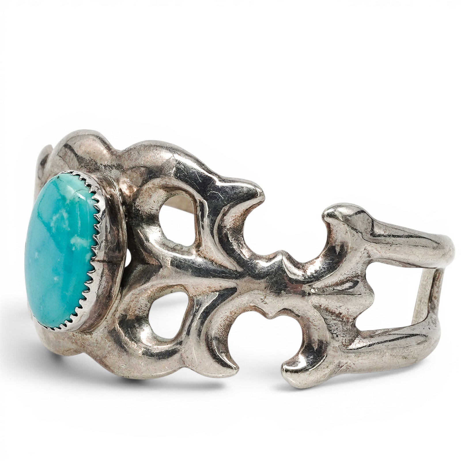 A Francis L. Begay Navajo Sterling Silver And Turquoise Openwork Cuff Bracelet: A Francis L. Begay Navajo sterling silver and turquoise openwork cuff bracelet Late 20th century Stamped: F.L. Begay / Sterling. A wide openwork cuff with flowing pierced silverwork centered by an ova