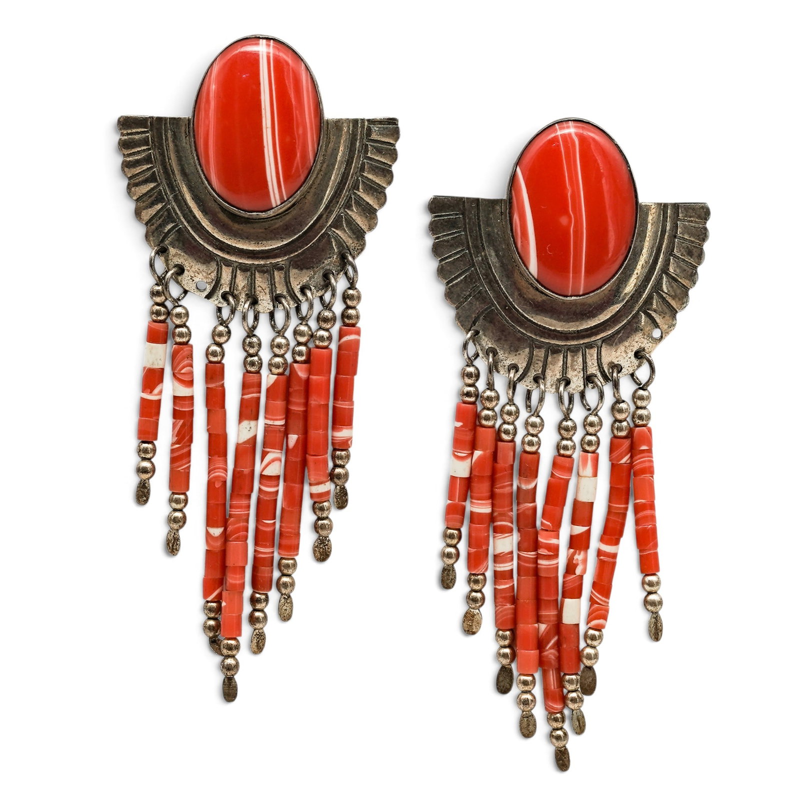A Pair Of Navajo Sterling Silver And Coral Fringe Earrings: A pair of Navajo sterling silver and coral fringe earrings Late 20th century Stamped: Sterling Each fan-form earring is set with an oval coral cabochon in a smooth bezel, with stamped radiating