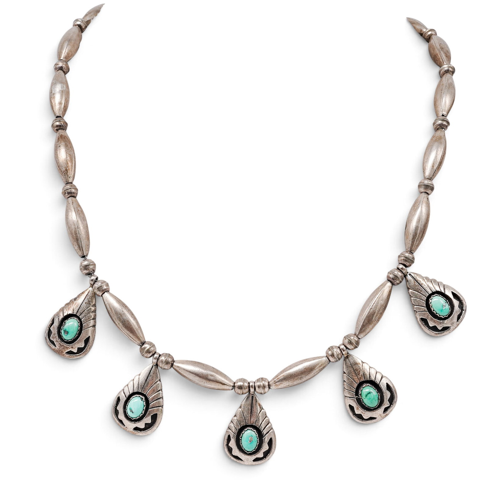 A Navajo Sterling Silver And Turquoise Feather Motif Beaded Necklace: A Navajo sterling silver and turquoise feather motif beaded necklace Late 20th century Stamped: Sterling. A necklace composed of elongated silver beads and silver bead strands, centered by five feathe