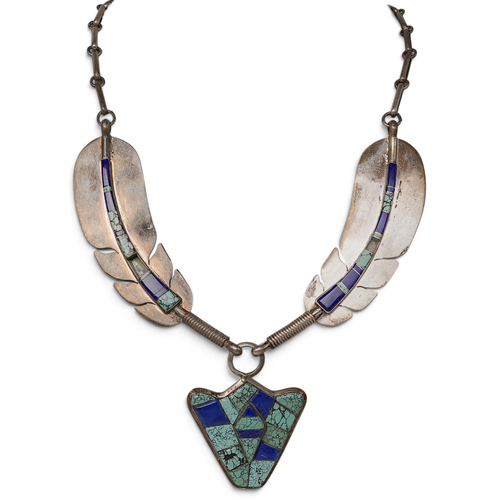 A Raymond Delgarito Navajo Sterling Silver, Turquoise, And Lapis Lazuli Feather Necklace: A Raymond Delgarito Navajo sterling silver, turquoise, and lapis lazuli feather necklace Late 20th century Raymond Delgarito (b. 20th century, Navajo) Stamped: R within a stylized D / Sterling A