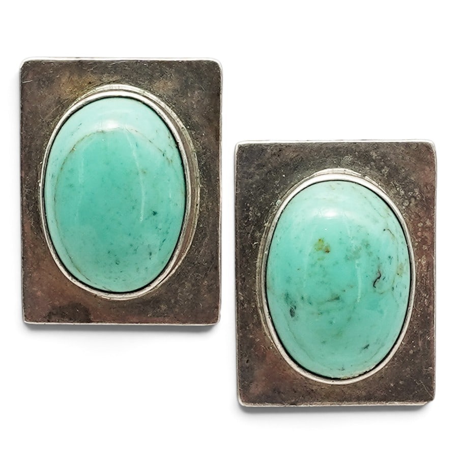 A Pair Of Mexican Sterling Silver And Turquoise Stud Earrings: A pair of Mexican sterling silver and turquoise stud earrings Late 20th century Stamped: Mexico / 925. Each with an oval turquoise cabochon bezel set within a rectangular silver plaque. 18.8 grams