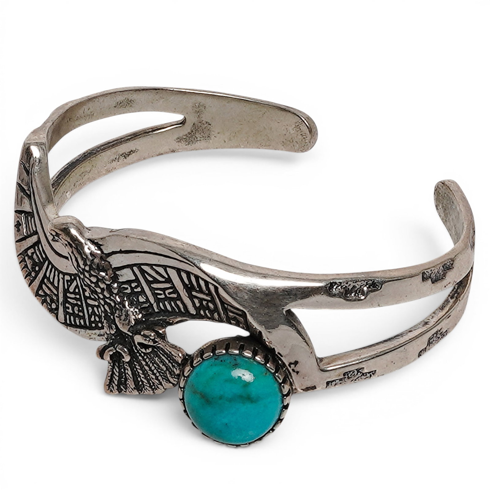 A Roderick & Marilyn Tenorio For Relios Sterling Silver And Turquoise Eagle Motif Cuff Bracelet: A Roderick & Marilyn Tenorio for Relios sterling silver and turquoise eagle motif cuff bracelet Late 20th century Stamped: RMT / Relios hallmark / .925. A sterling silver cuff bracelet with an applied