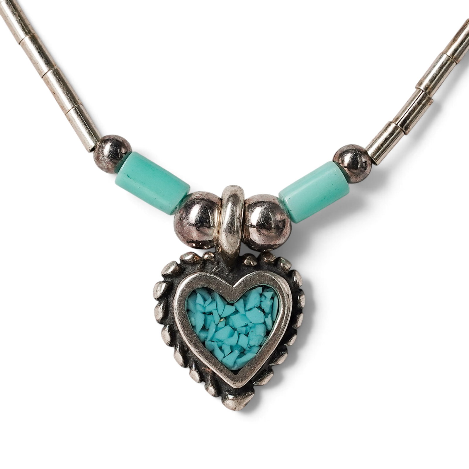 A Navajo Sterling Silver And Turquoise Heart Station Necklace: A Navajo sterling silver and turquoise heart station necklace Late 20th century Stamped: Sterling / [unidentified pictograph] A fine silver tube-link necklace with turquoise bead stations and a heart-