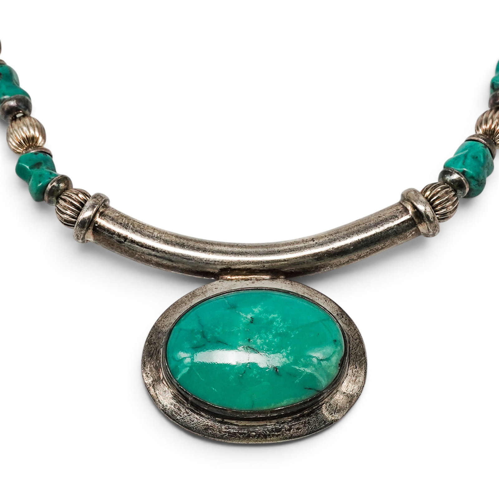 A Navajo Sterling Silver And Turquoise Beaded Pendant Necklace: A Navajo sterling silver and turquoise beaded pendant necklace Late 20th century Unmarked. Tested sterling silver. A necklace composed of graduated turquoise nugget beads alternating with silver beads