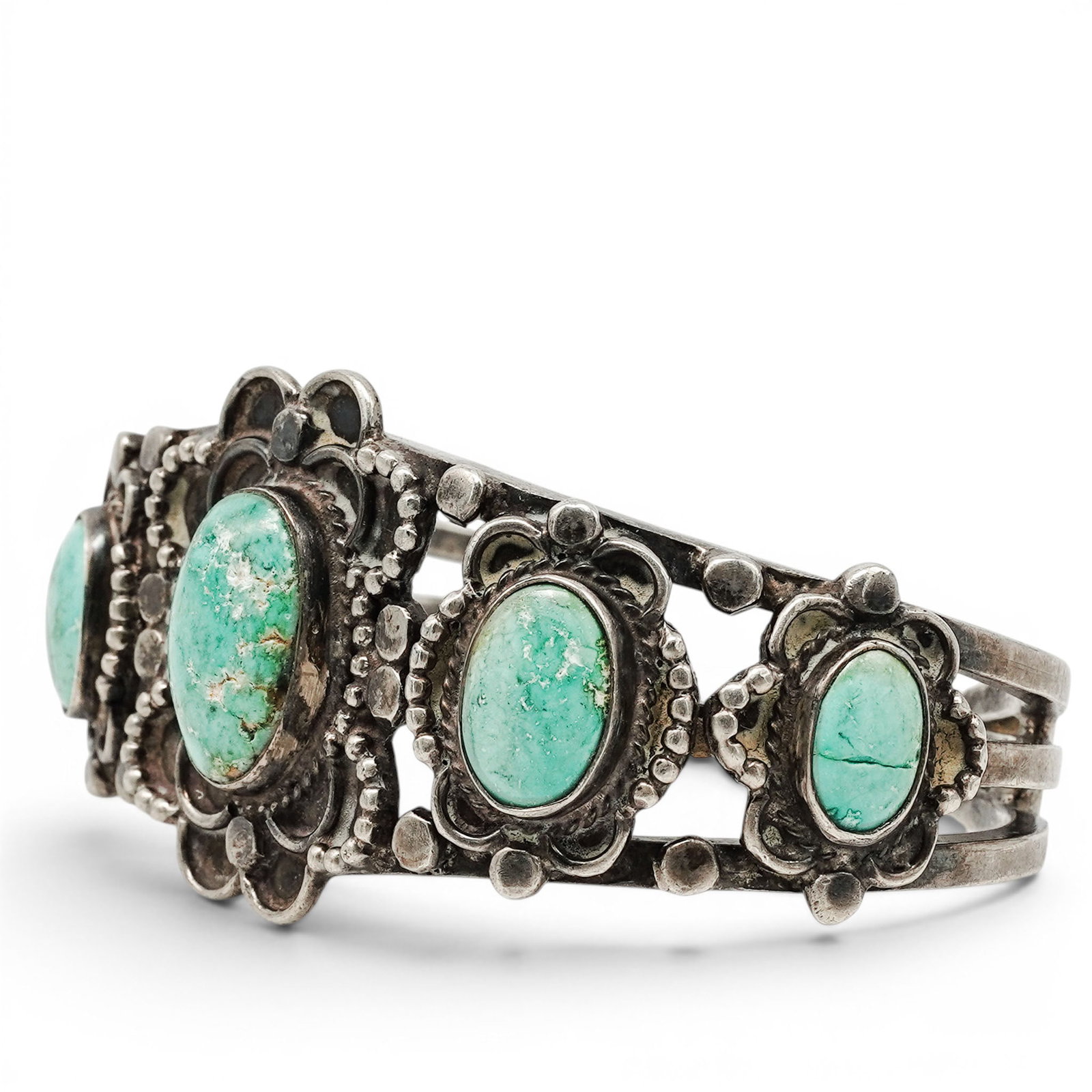 A Navajo Sterling Silver And Turquoise Cuff Bracelet: A Navajo sterling silver and turquoise cuff bracelet Late 20th century Stamped: B, unidentified hallmark / 15. Tested sterling silver. A cuff bracelet with five oval bezel set turquoise cabochons, acc