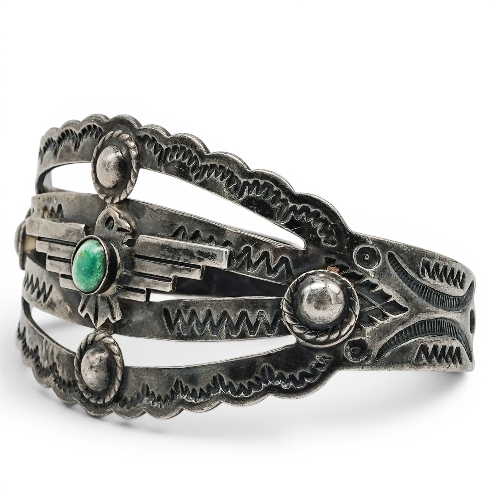 A Navajo Sterling Silver And Turquoise Thunderbird Motif Cuff Bracelet: A Navajo sterling silver and turquoise thunderbird motif cuff bracelet Late 20th Century Stamped: Sterling. A wide cuff bracelet with central thunderbird motif in stamped and applied silverwork, accen