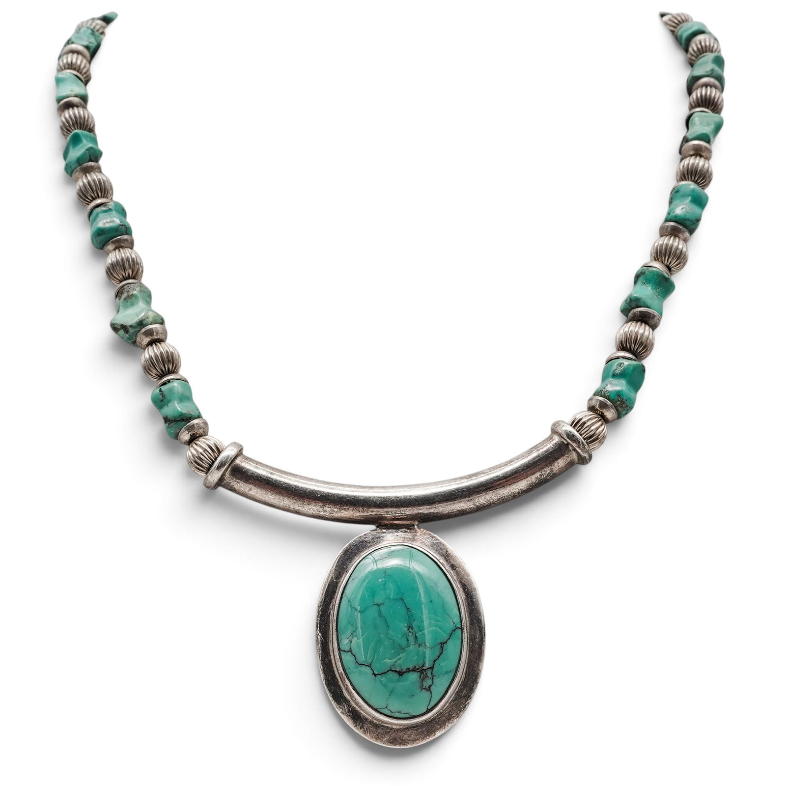 A Navajo Sterling Silver And Turquoise Beaded Pendant Necklace: A Navajo sterling silver and turquoise beaded pendant necklace Late 20th century Unmarked. Tested sterling silver. A necklace composed of turquoise and silver beads with tubular silver spacers, suspen