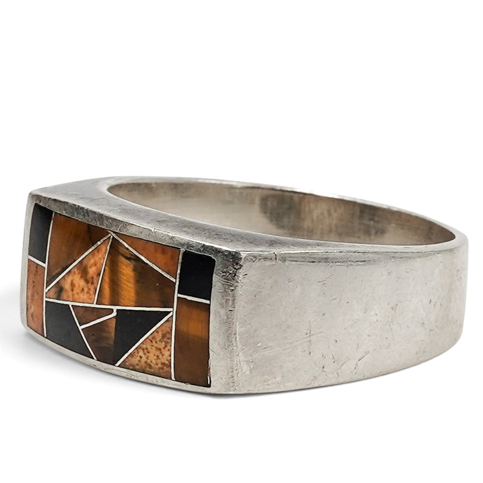 A Rick Martinez For GL Miller Studio Sterling Silver And Multistone Geometric Inlay Ring: A Rick Martinez for GL Miller Studio sterling silver and multistone geometric inlay ring Late 20th century Stamped: R. Martinez / .925 / G.L. A tapered band ring with channel-set geometric multistone 