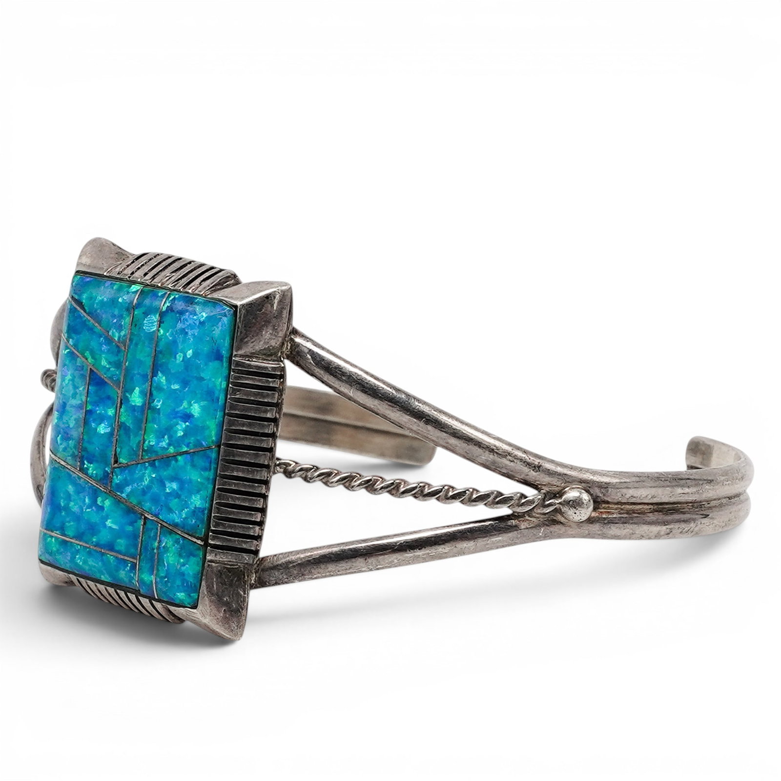 An E. Jackson Navajo Sterling Silver And Turquoise Mosaic Inlay Cuff Bracelet: An E. Jackson Navajo sterling silver and turquoise mosaic inlay cuff bracelet Late 20th century Stamped: E. Jackson / Sterling A wirework cuff bracelet centered by a square turquoise mosaic inlay pane