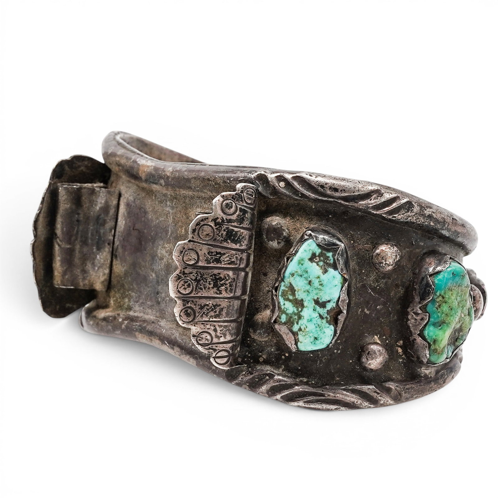 A Navajo Sterling Silver, Turquoise, And Coral Repoussé Cuff Bracelet: A Navajo sterling silver, turquoise, and coral repoussé cuff bracelet Late 20th Century Unmarked. Tested sterling silver. A heavy cuff bracelet with repoussé and applied silverwork decoration, set w