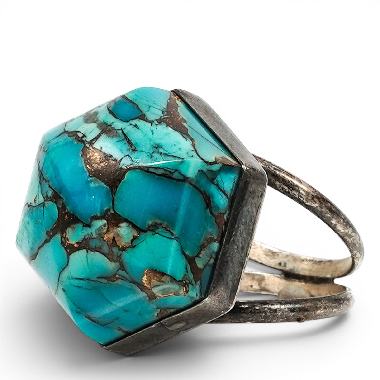 A Southwest Style Silver And Turquoise Ring: A Southwest Style silver and turquoise ring Late 20th Century, Chinese Stamped: Desert Rose Trading China .925 A ring set with a large hexagonal turquoise cabochon in a serrated bezel mount on a split