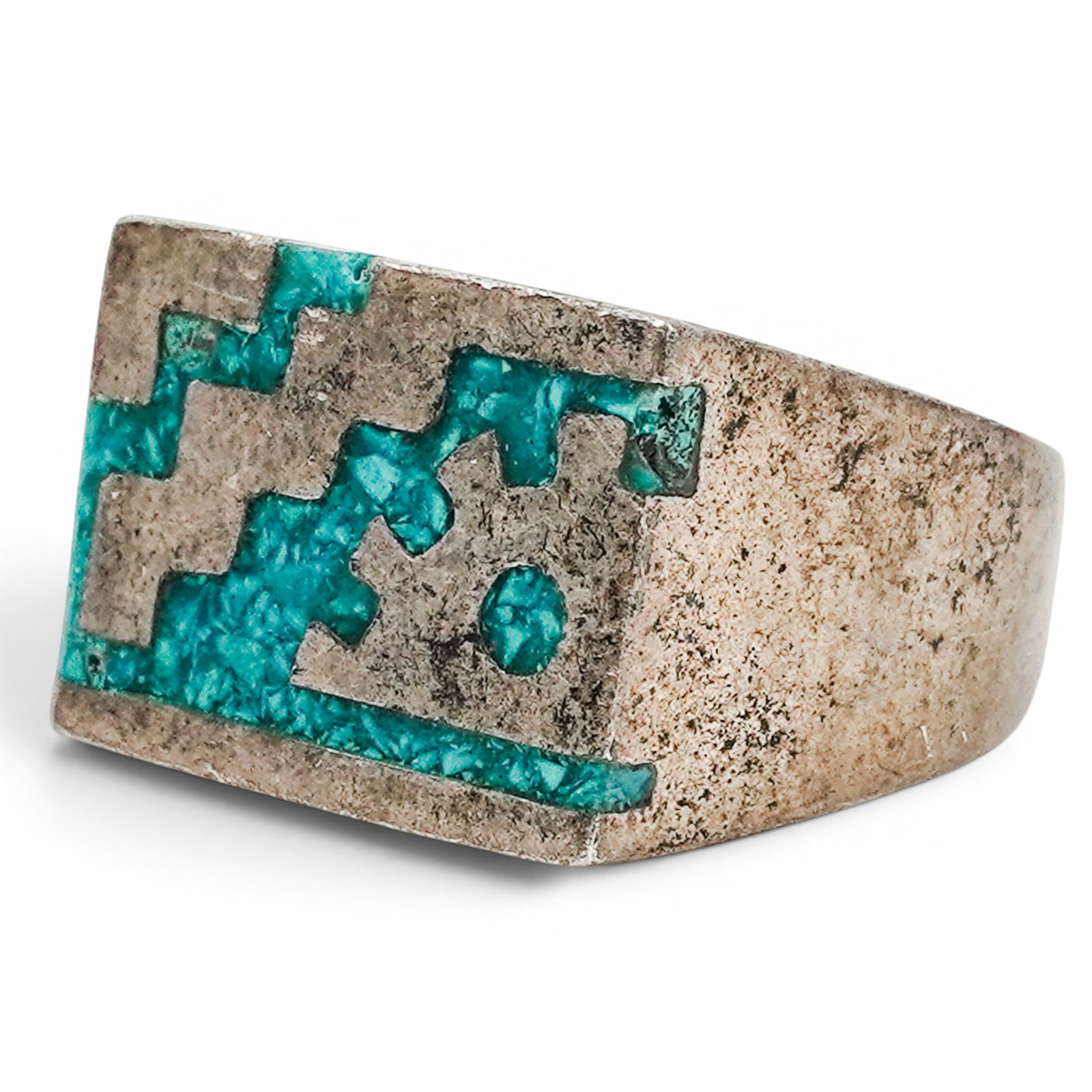 A Mexican Sterling Silver And Turquoise Geometric Inlay Ring: A Mexican sterling silver and turquoise geometric inlay ring Late 20th century Stamped: Mexico / .925 A substantial rectangular ring with turquoise geometric mosaic inlay depicting stepped motifs and 