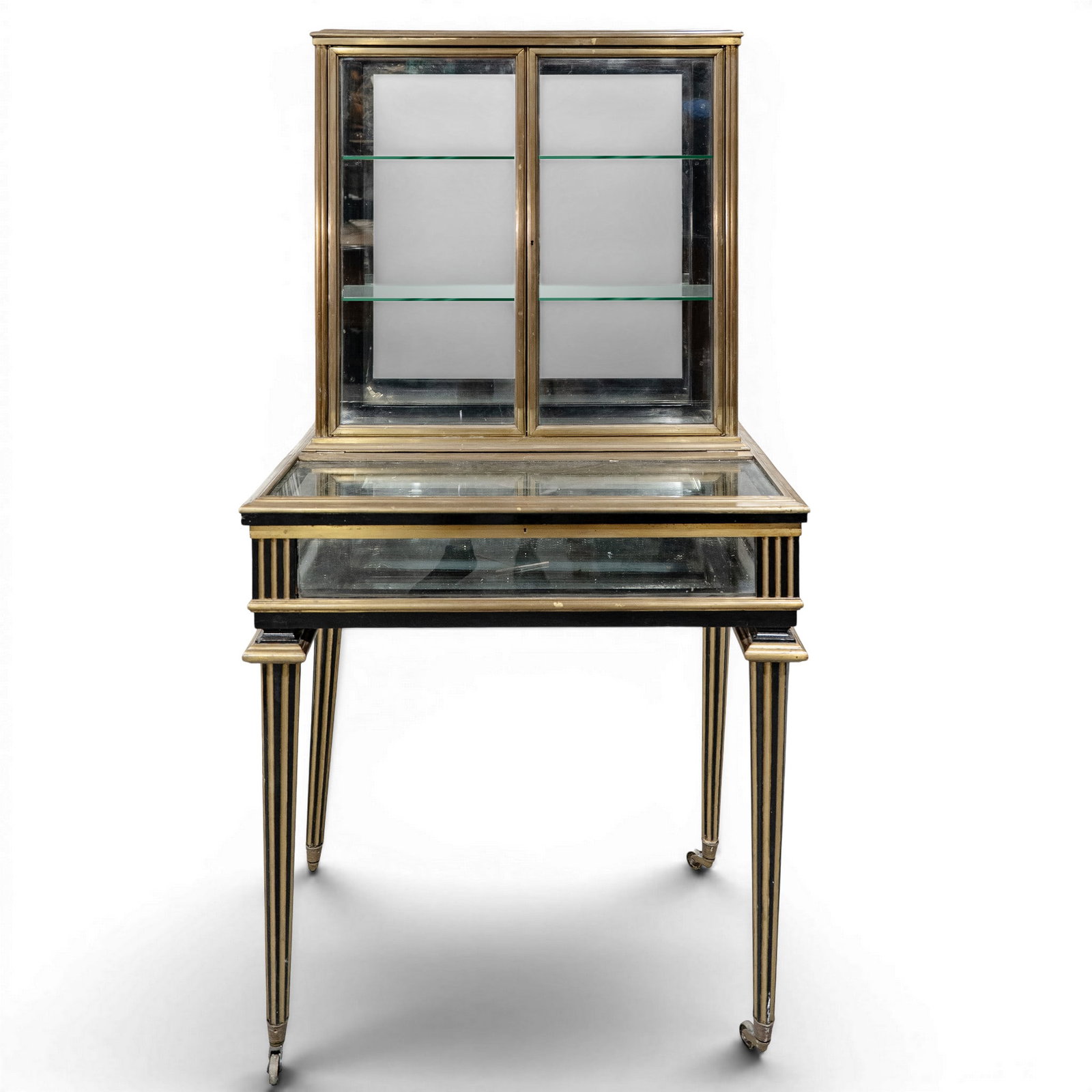 Antique Bronze and Mirrored Vitrine: Antique Bronze and Mirrored Vitrine Early 20th century, French An antique vitrine crafted from ebonized wood, accented with polished bronze fluting, moldings, and trim. Built as a multi-tiered