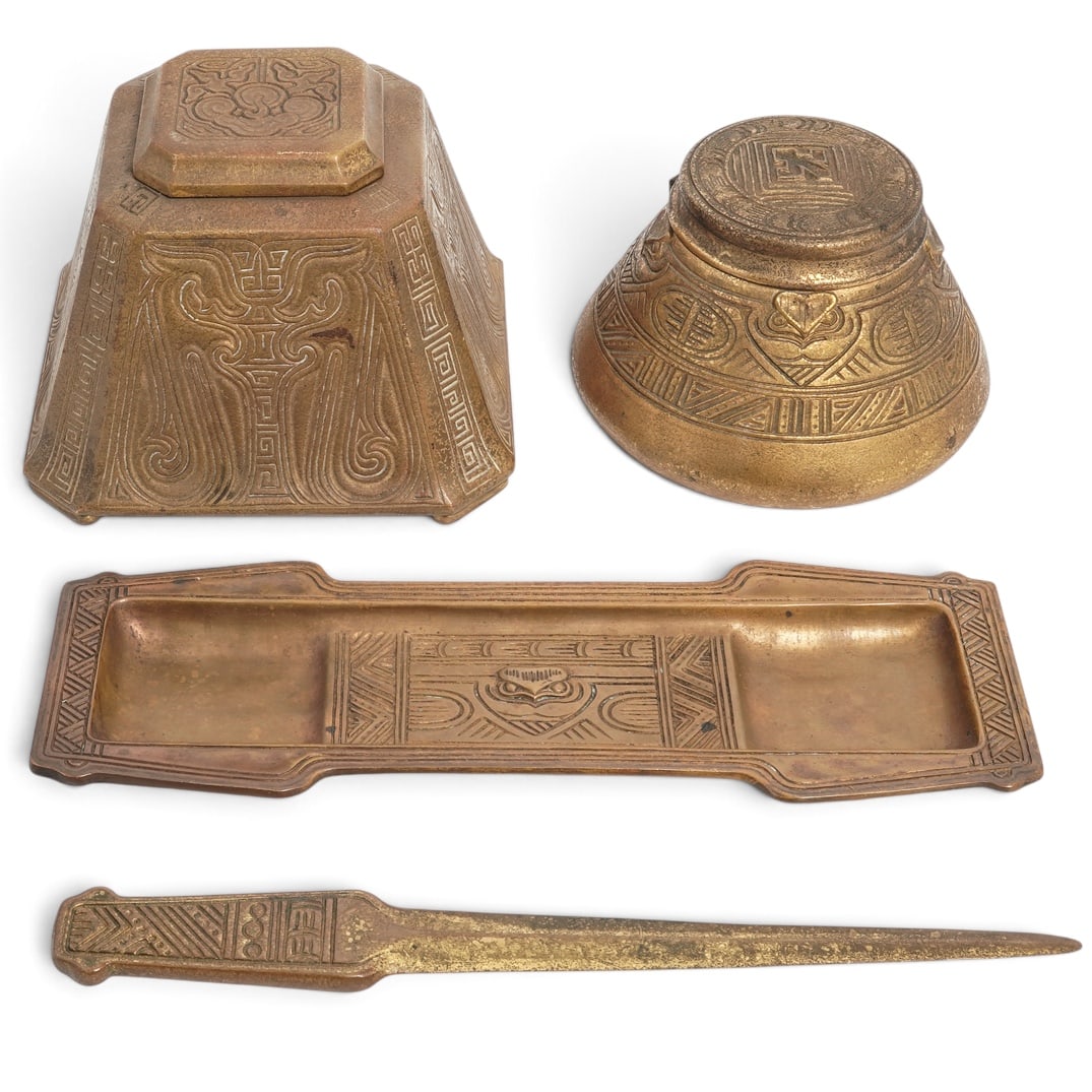 (4 pcs) Tiffany Studios "American Indian" Bronze Desk Set: (4 pcs) Tiffany Studios "American Indian" Bronze Desk Set Early 20th century, American Three pieces of Tiffany Studios "American Indian" pattern gilt bronze desk set along with one ink well in the "Ch