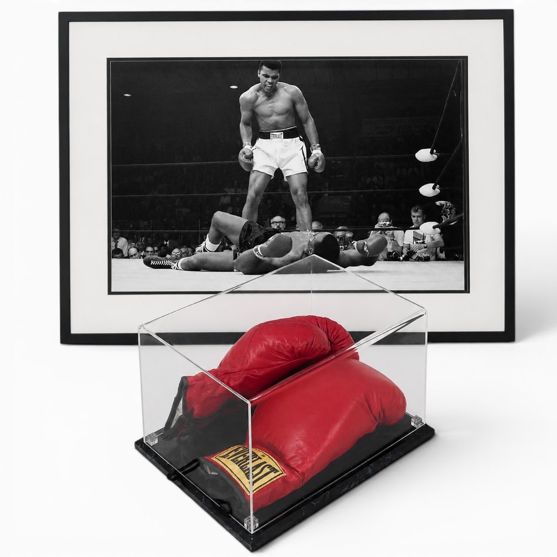 (2 pc) Muhammad Ali Everlast Signed Boxing Gloves & Poster: (2 pc) Muhammad Ali Everlast Signed Boxing Gloves & Poster 20th century, USA The signature is rendered in fine-line ink directly across the main padded body of the glove. The cursive style matches the