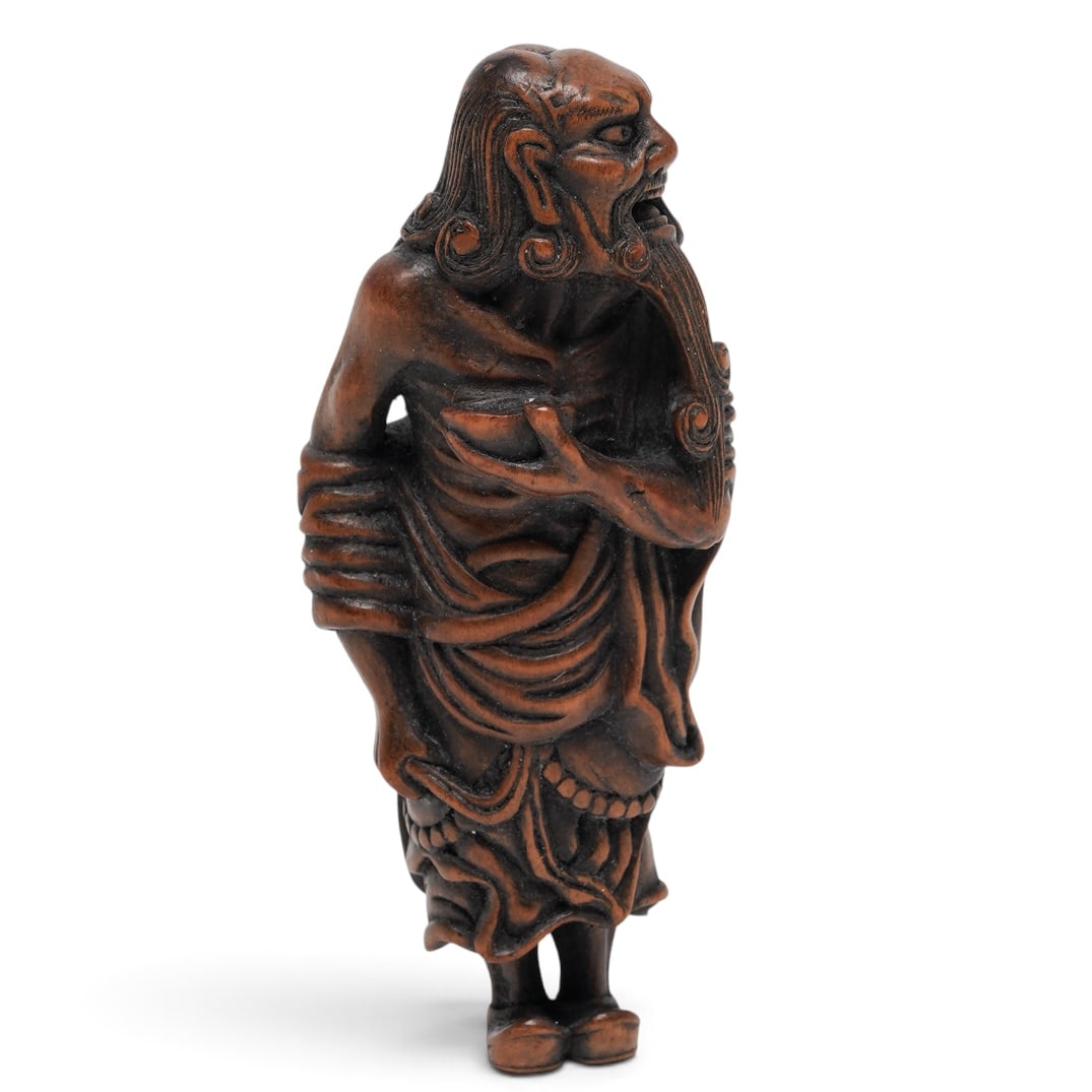 Japanese Boxwood Netsuke of Sennin: Japanese Boxwood Netsuke of Sennin Late 18th-early 19th century, Japanese A large example of a finely carved Japanese boxwood netsuke of a Sennin or Dutchman, curling hair, long flowing robe, bear, an