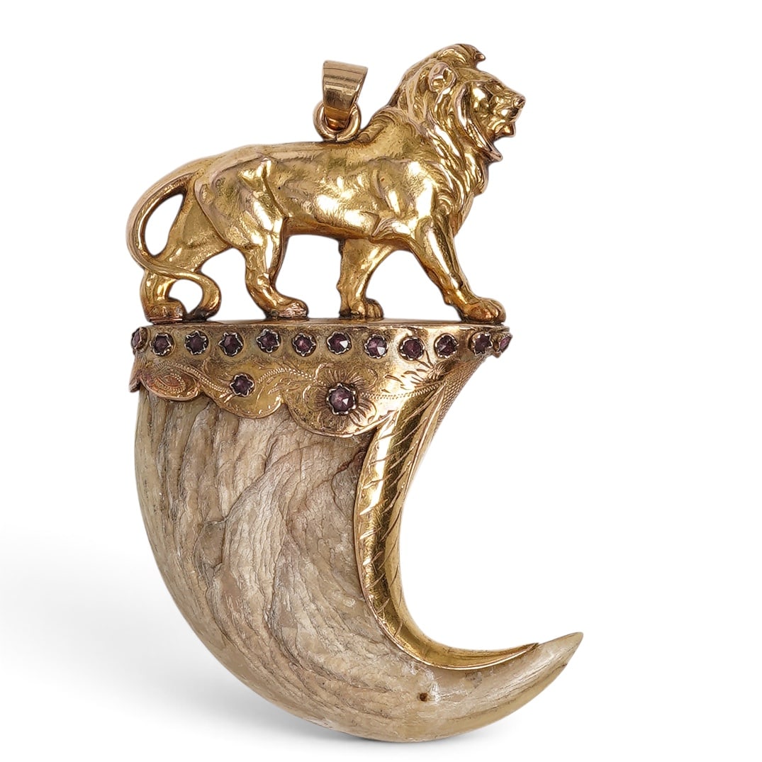 19th Cent. French Gold Lion Claw Pendant: 19th Cent. French Gold Lion Claw Pendant 19th century, French A 19th century French gold pendant featuring mine-cut gems and engraved floral detail, holding a lion claw. The top features a finely