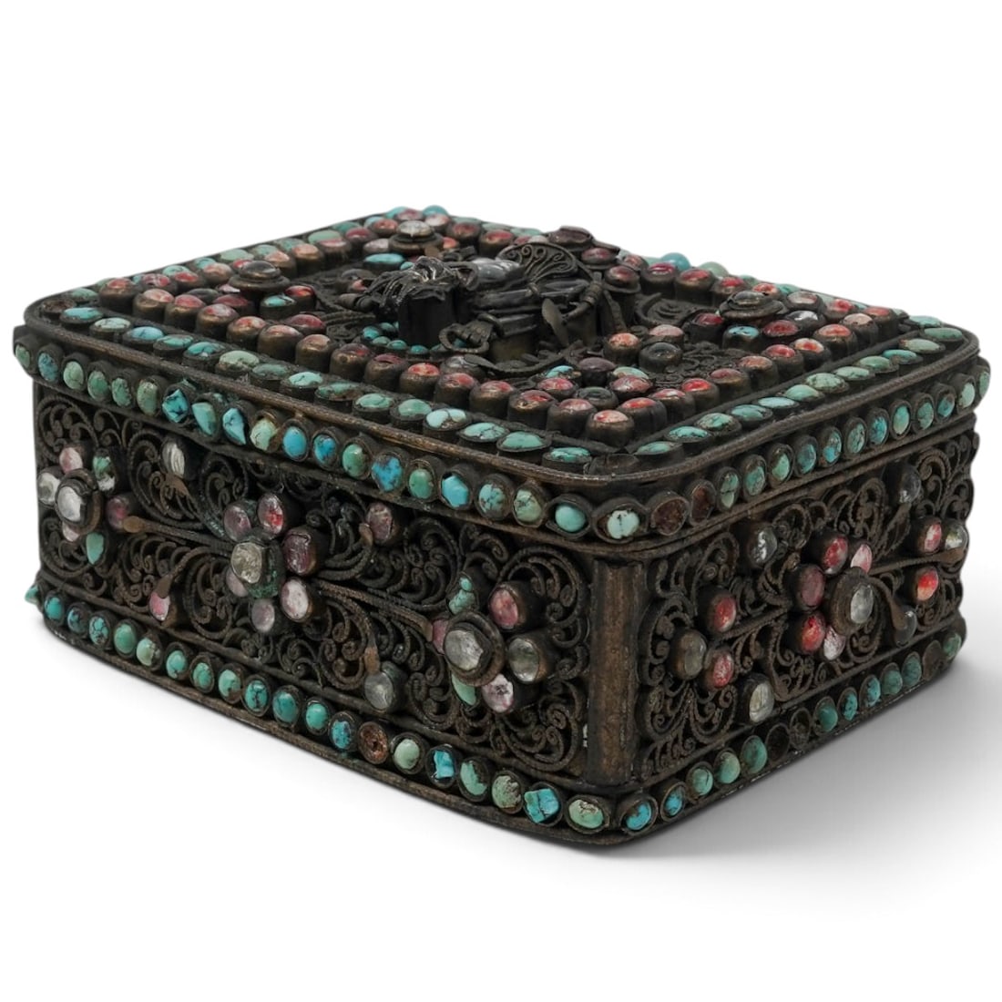 Nepalese Jeweled Copper Hinged Box: Nepalese Jeweled Copper Hinged Box Late 19th-early 20th century, Nepalese A rectangular shaped box with fine filigree work, embellished with turquoise and glass jewels. On the top of lid is a three di