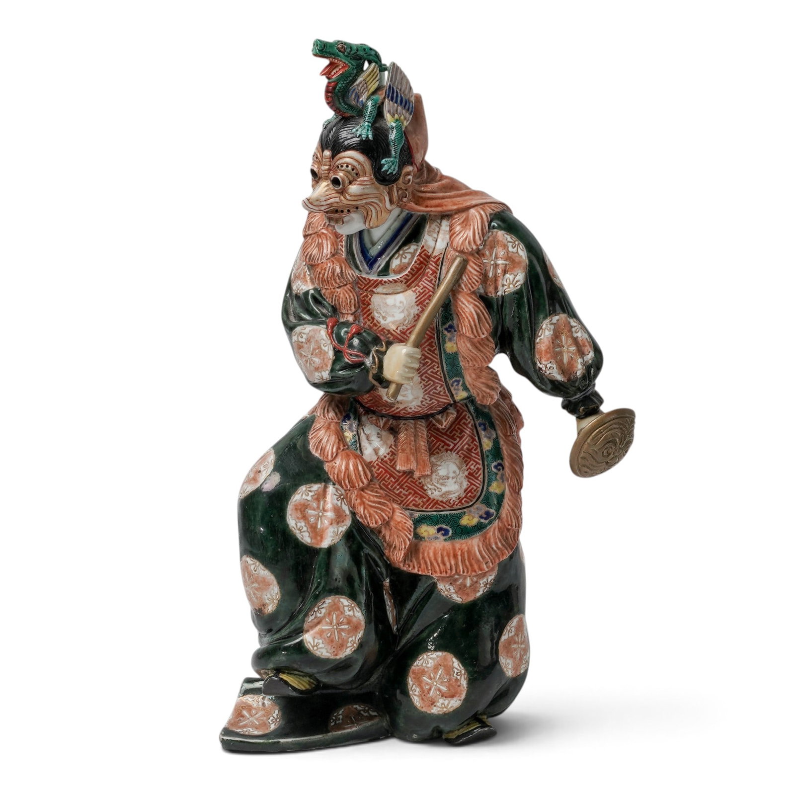 Large Japanese Kutani Porcelain Masked Dancer Statue: Large Japanese Kutani Porcelain Masked Dancer Statue Late 19th to Early 20th Century, Japan The statue with one leg raised, one hand holding a shield, the other a stick, wearing a mask with a winged d