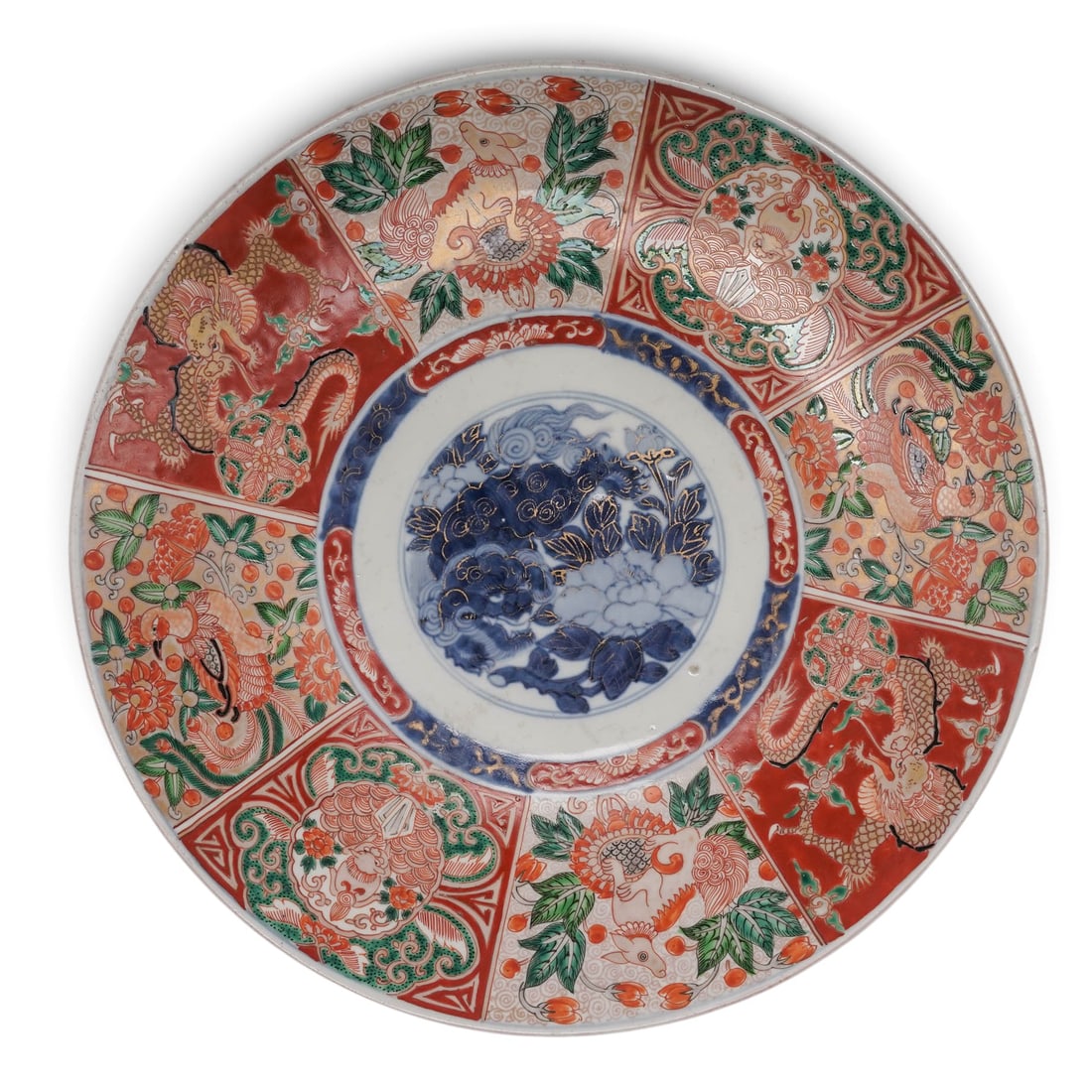 Japanese Imari Porcelain Charger: Japanese Imari Porcelain Charger Meiji period, Japanese a Japanese Meiji period Imari porcelain charger. The center panel with underglaze blue Shishi dog and peony flowers highlighted with gilt. Eight