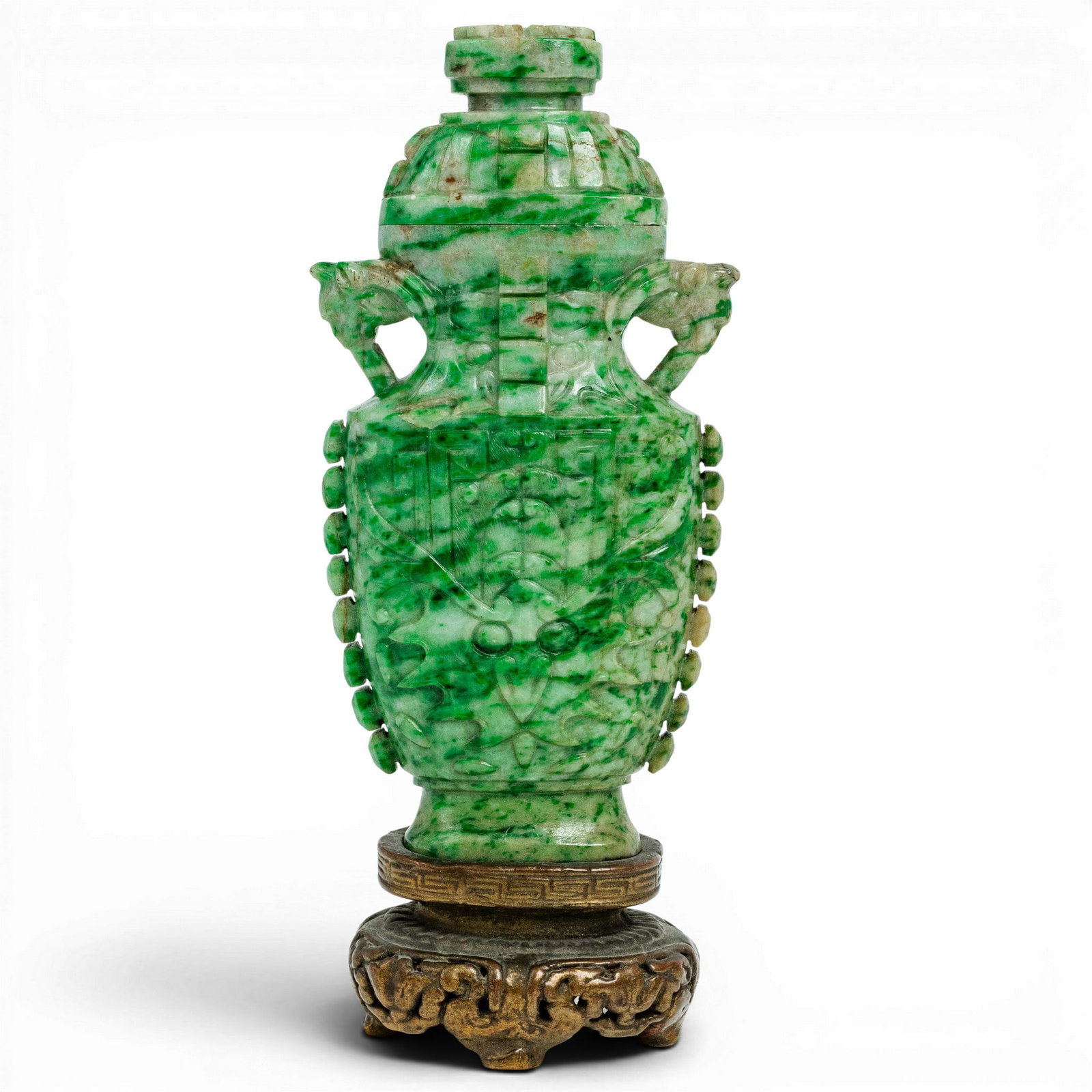 Antique Chinese Archaic Style Jadeite Lidded Vase On Stand: Antique Chinese Archaic Style Jadeite Lidded Vase On Stand Late 19th-early 20th century, Chinese Jadeite lidded urn featuring archaic style carvings on the side depicting tao tie in low relief. Piece 