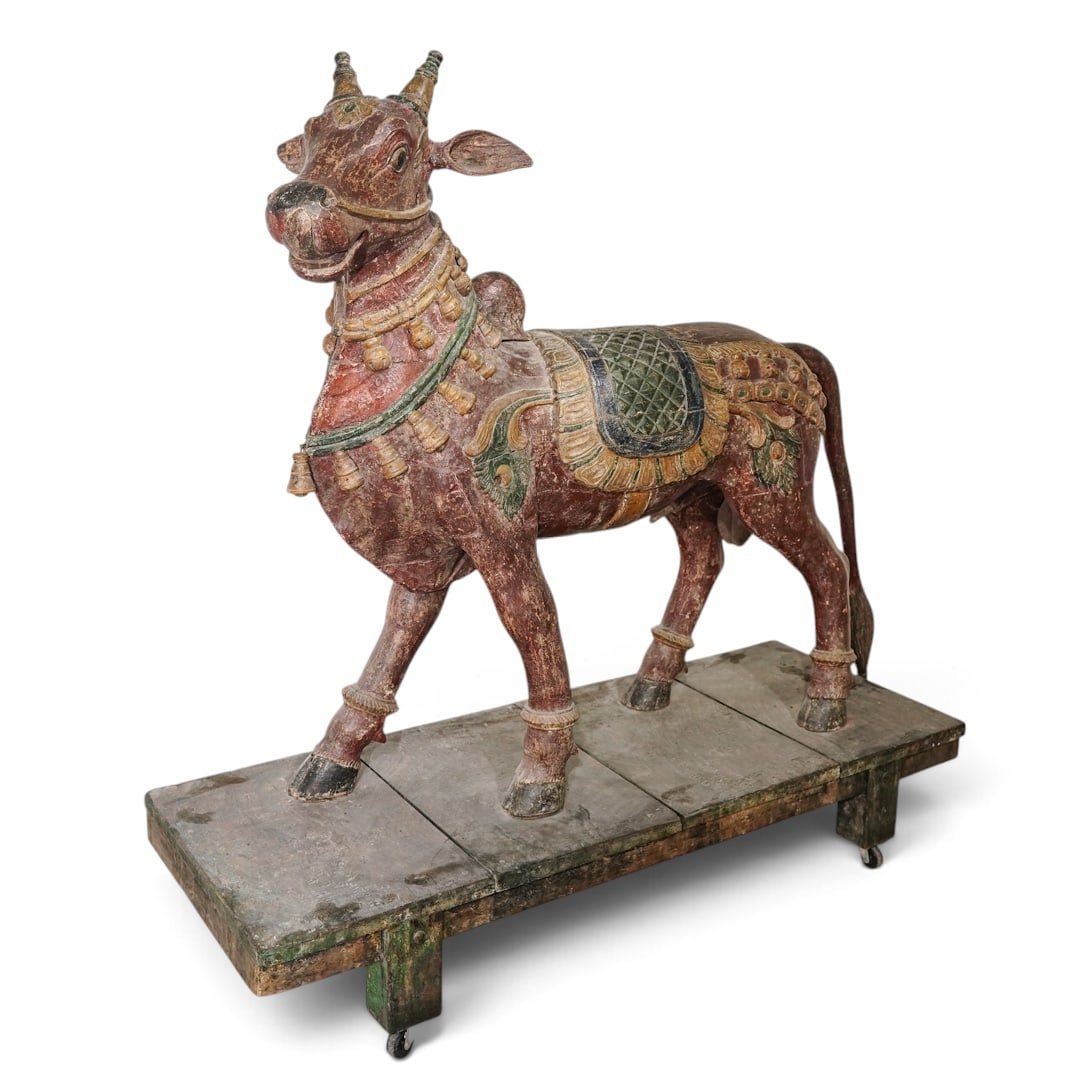 Large Indian Sacred Nandi Bull Vahana Polychrome Wood Sculpture: Large Indian Sacred Nandi Bull Vahana Polychrome Wood Sculpture Late 19th-early 20th century, Indian The bull is standing on all four legs with the head slightly turned. Hoofs are painted black. The s