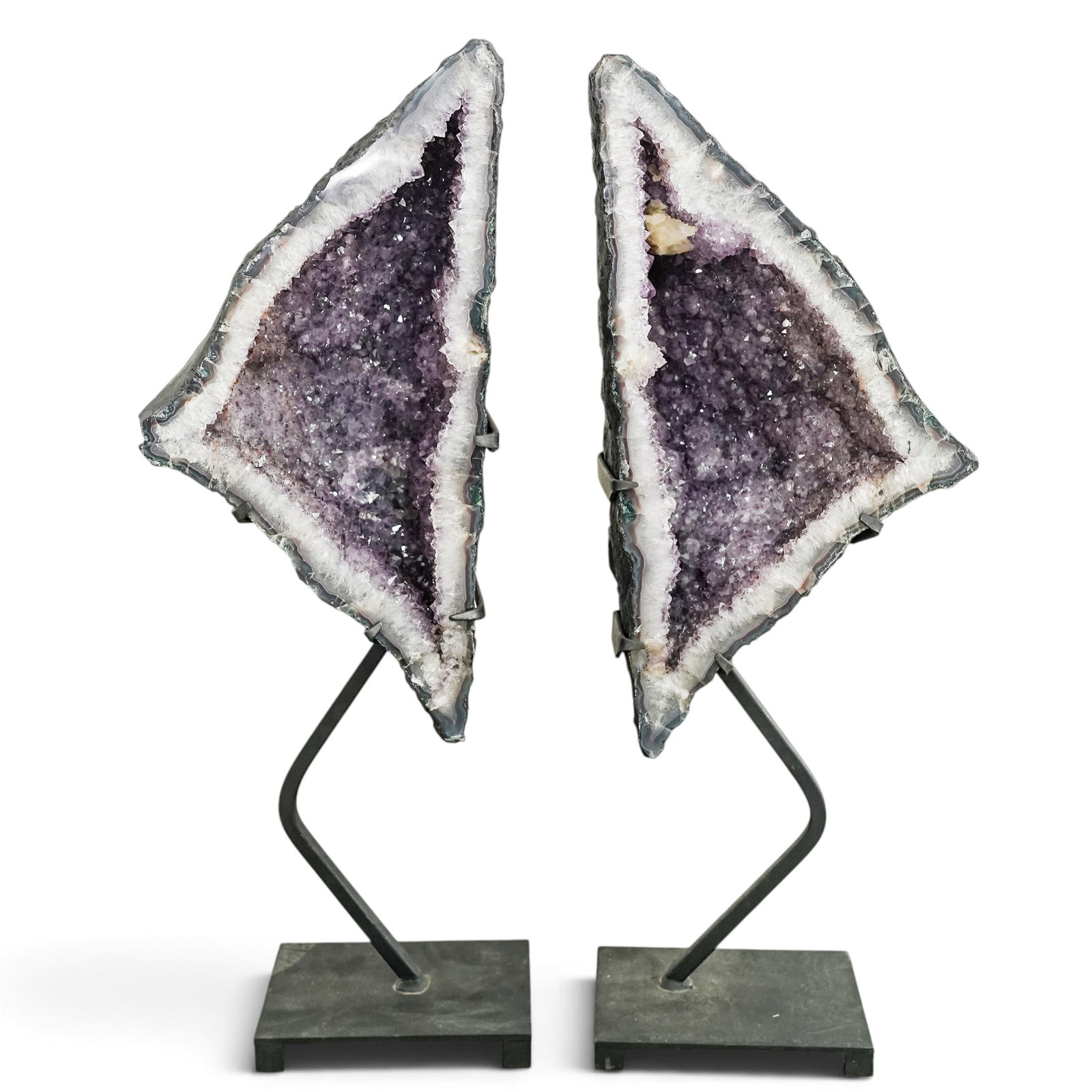 Pair Triangular Amethyst Geode Cathedrals with Stands: Pair Triangular Amethyst Geode Cathedrals with Stands 20th Century, Brazil A pair of natural amethyst cathedral geodes of complementary triangular form, each featuring a deep open cavity lined with