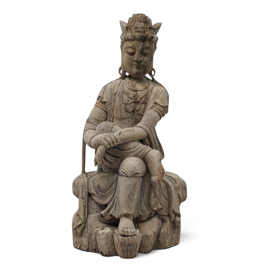 Antique Carved Wood Guanyin Sculpture: Antique Carved Wood Guanyin Sculpture Late 19th Century, China A large Chinese carved wood Guanyin sculpture, depicted seated in a relaxed pose with one leg raised and the other lowered, wearing flowi