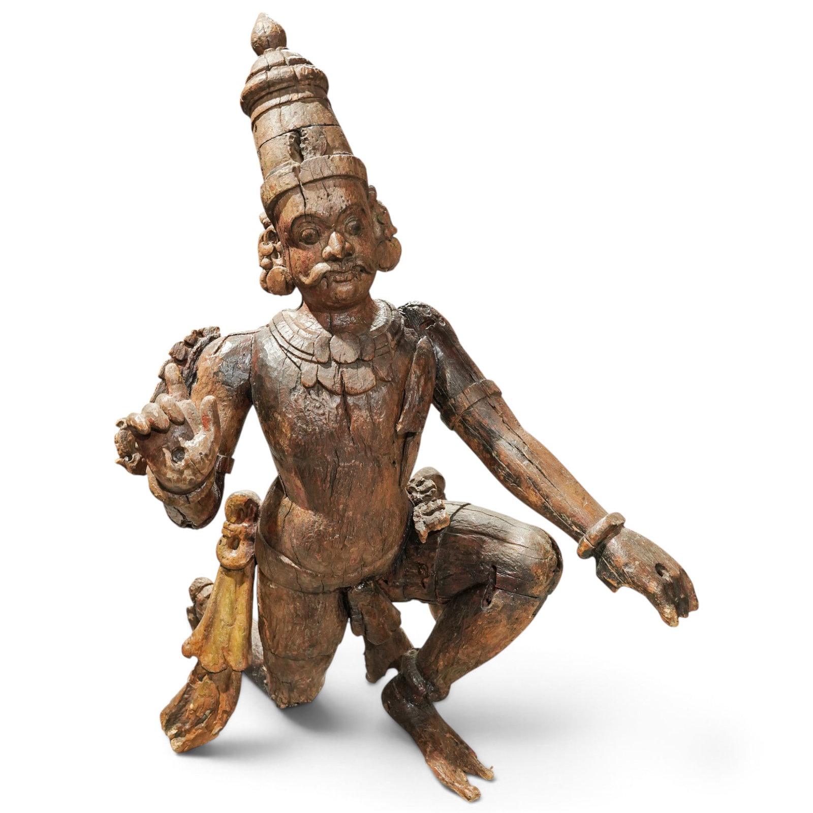 Antique Large Indian Wood Carved Temple Guardian Sculpture: Antique Large Indian Wood Carved Temple Guardian Sculpture 18th-19th Century, Southern India Large antique carved wood temple guardian figure, depicted in a kneeling pose with one hand raised and the