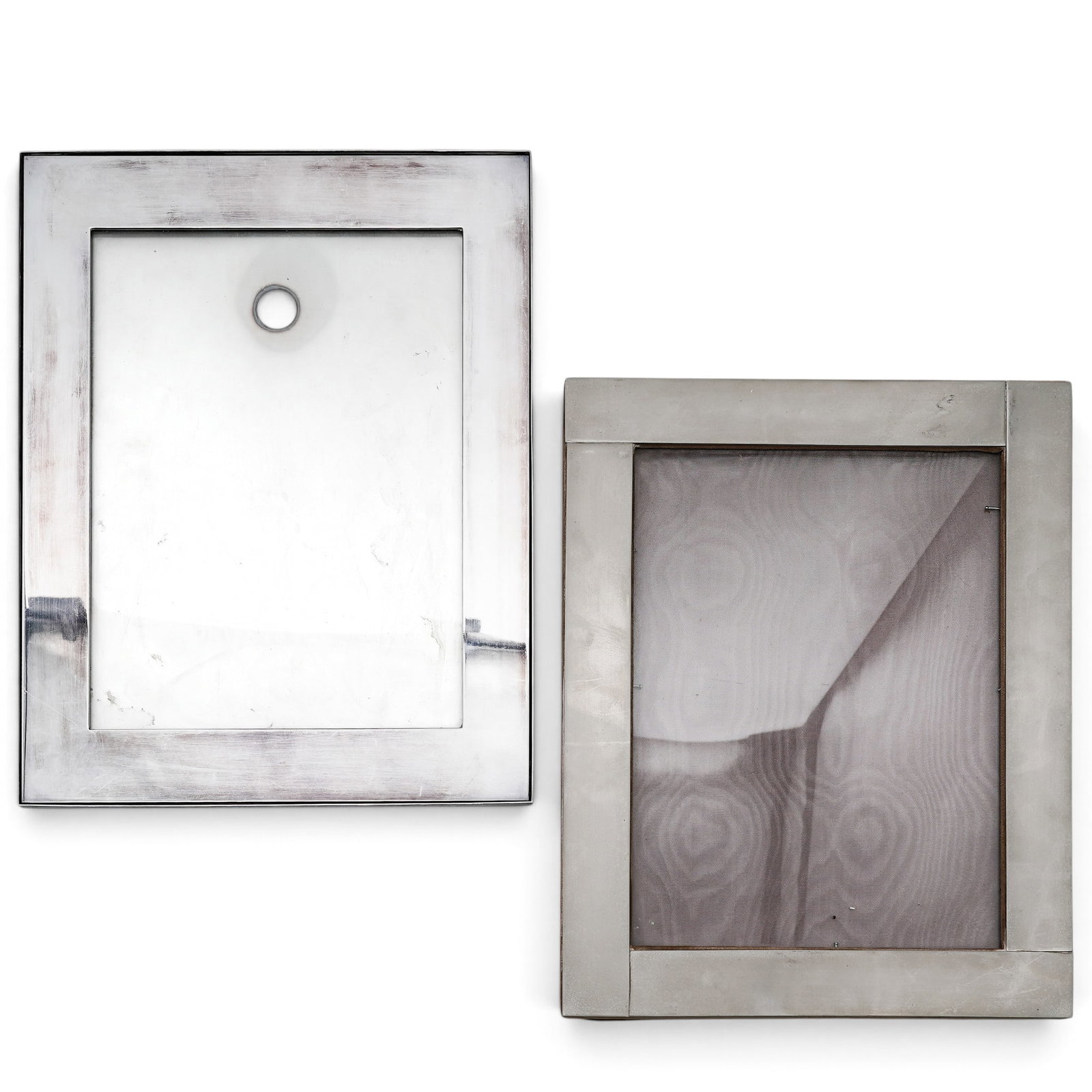 (2pc) Vintage Silver & Silver Plated Frames: (2pc) Vintage Silver & Silver Plated Frames Mid 20th Cent. The lot includes: (1) A sterling silver picture frame featuring a smooth metallic reverse panel bordered by a thin rim and equipped with a