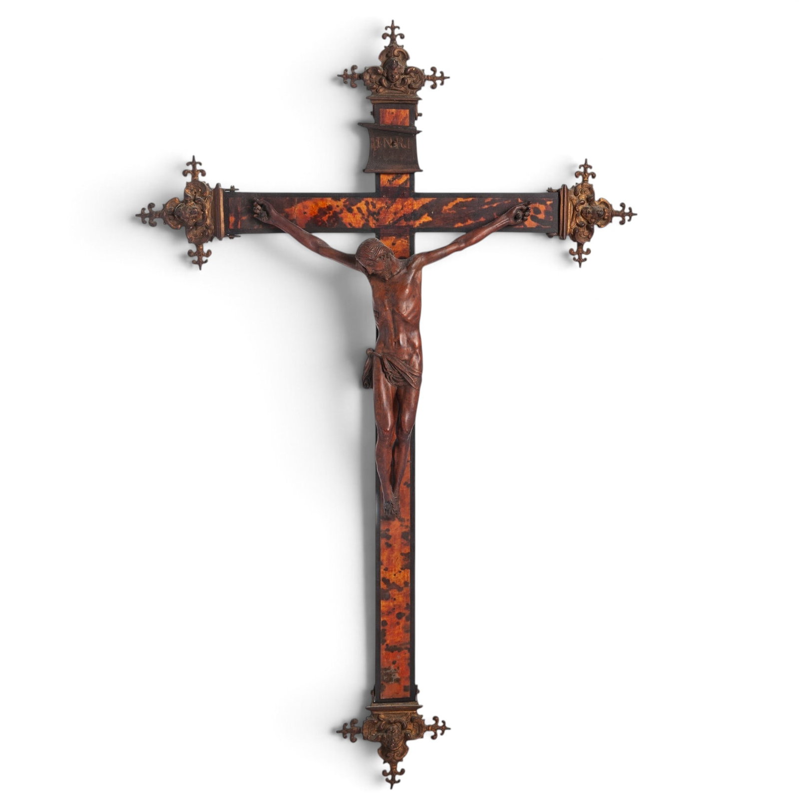 Antique Carved Wood & Tortoise Hue Crucifix: Antique Carved Wood & Tortoise Hue Crucifix 19th Cent, European Hand carved wooden crucifix and corpus christi, with a tortoise shell hue, and cast metal terminal mounts. Plaque marks IRNI hangs
