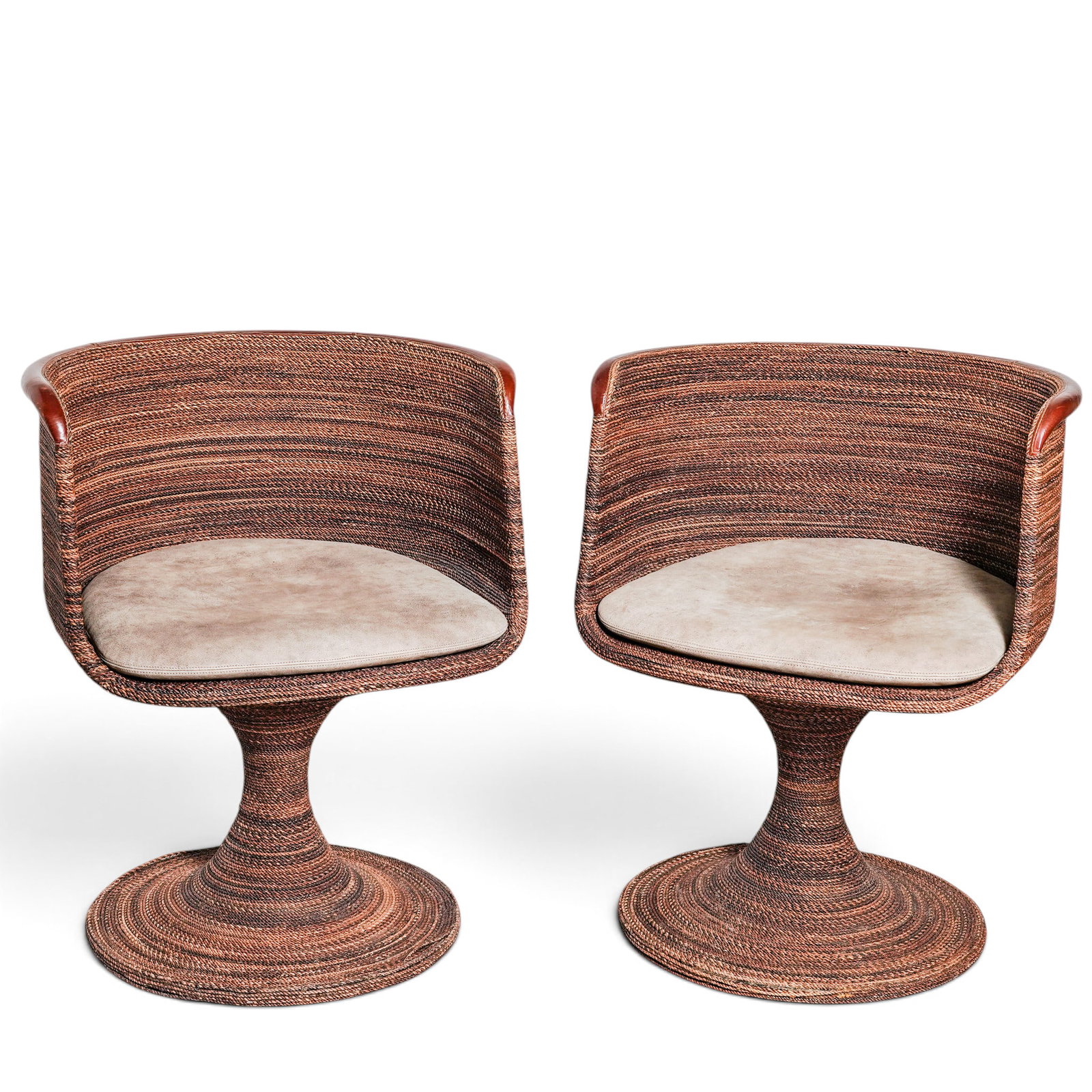 Pair of Pride Sasser Rattan Swivel Bucket Chairs: Pair of Pride Sasser Rattan Swivel Bucket Chairs Late 20th Century, Philippines A pair of sculptural swivel bucket chairs designed by Pride Sasser Home Furnishings, featuring organically curved rattan