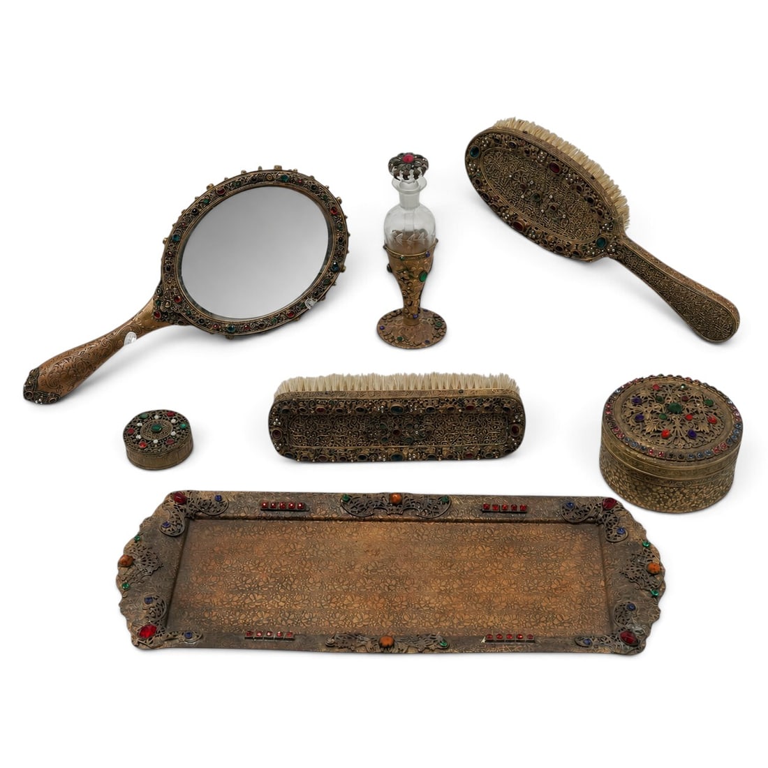 (7pc) Antique French Gold Plate Jeweled Dresser Set: (7pc) Antique French Gold Plate Jeweled Dresser Set Circa 1920-1930. French A dressing table set featuring a heavy, ornate gold-plated finish, decorated with dense, intricate filigree scrollwork, and