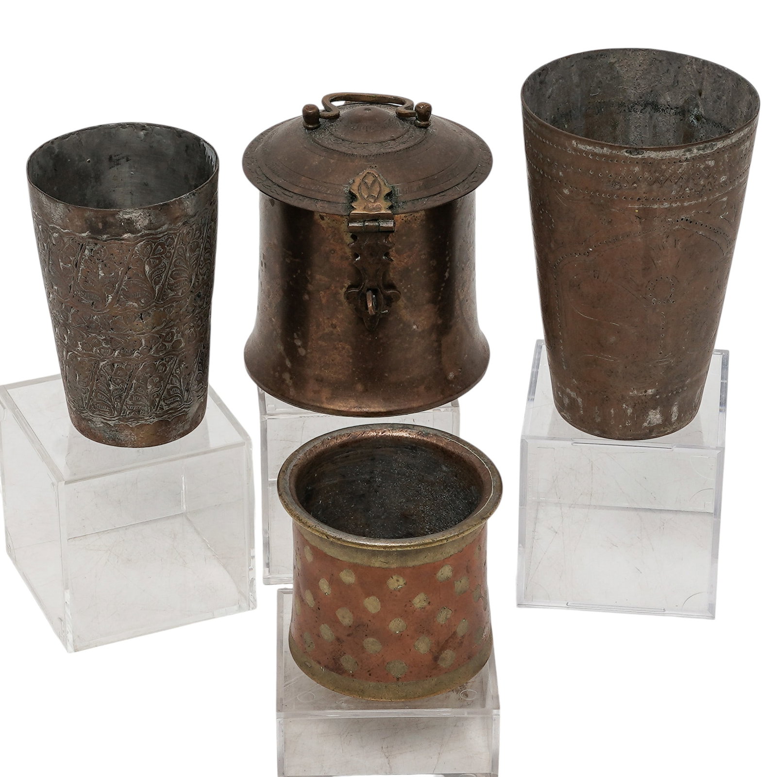(4 pc) Indian Copper & Brass Cups & Lidded Jar: (4 pc) Indian Copper & Brass Cups & Lidded Jar 20th Century, India A four-piece grouping of Indian copper and brass vessels, comprising a vintage brass tobacco jar, a brass and copper Ganga Jamuna cer