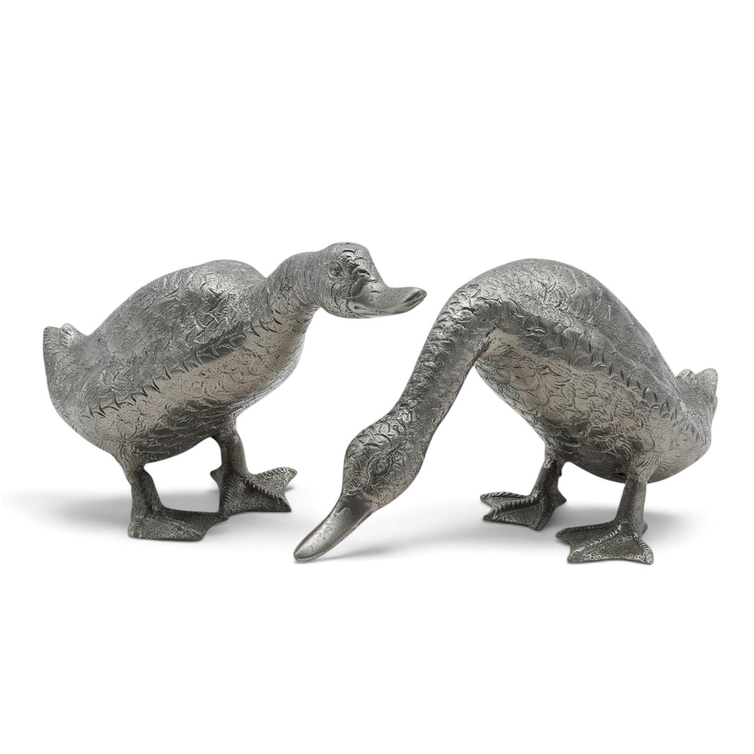(2 pc) Cast Metal Geese Figurines: (2 pc) Cast Metal Geese Figurines 20th Cent, Likely Spain/USA Two cast metal figurines of geese one in a grazing position, and one with head held high. Feathered pattern throughout each goose's body.