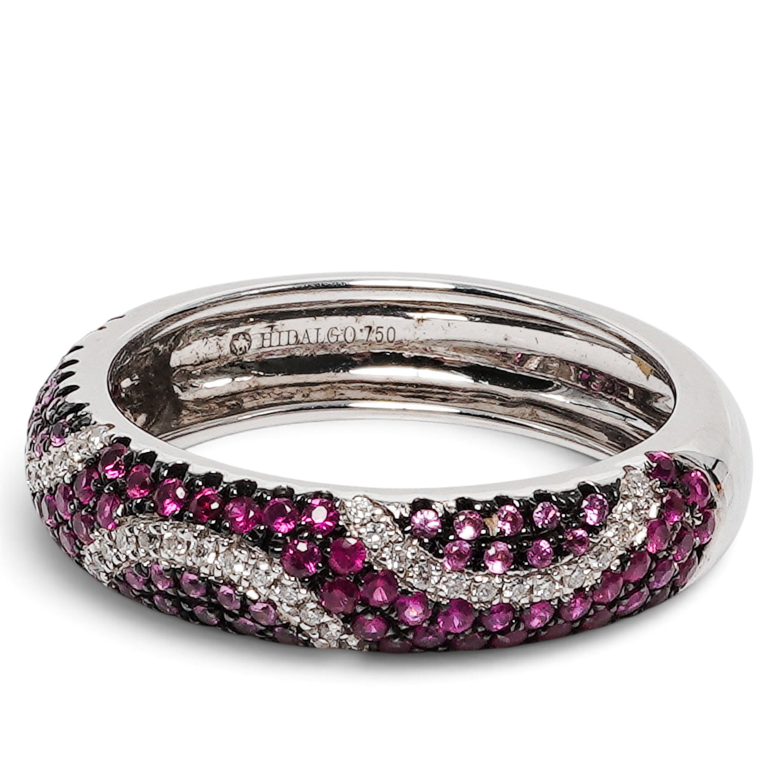 Hidalgo 18K Gold Ruby & Diamond Band: Hidalgo 18K Gold Ruby & Diamond Band 2000s - 2010s, USA 18K white gold domed pavé band set with approx. 1.74 ctw rubies, approx. 0.06 ctw sapphires, and approx. 0.82 ctw diamonds in multi-row pavé s