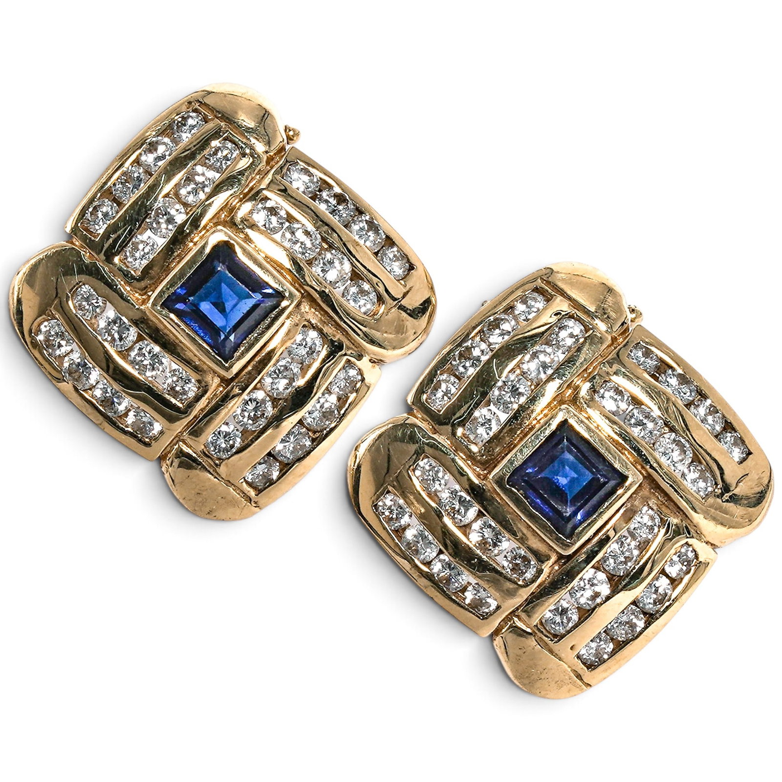 18K Gold Sapphire and Diamond Huggie Earrings: 18K Gold Sapphire and Diamond Huggie Earrings Late 20th Century 18K yellow gold huggie earrings with square blue sapphire centers, channel-set diamond rows, and hinged backs, set with approx. 0.60